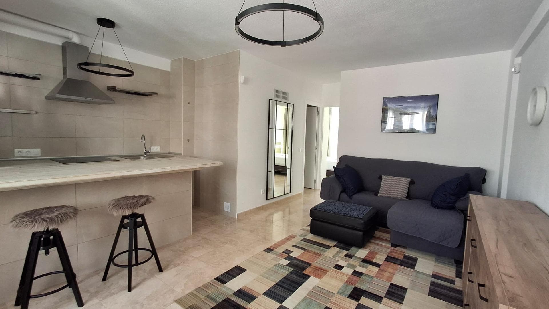 2 bedroom apartment just 50 meters from the beach, with side sea views and fully renovated, ideal as a permanent residence, holiday home, or investment. The property features two bedrooms with high-quality beds and mattresses, as well as built-in wardrobes that provide convenient storage space. It includes a fully equipped bathroom with a bathtub, bidet, vanity unit, and mirror. The living area is integrated with an open-plan American-style kitchen with an island, fully equipped with appliances, creating a modern, practical, and functional space. The living room is furnished and includes a sofa and a foldable table, optimizing the use of space. One of the highlights of the property is its two large vertical folding windows, which provide plenty of natural light, sea view, ventilation and gives a pleasant atmosphere. The property has been upgraded with a complete plumbing renovation, new windows and doors with thermic and acoustic insulation, as well as a new water heater, ensuring greater comfort and efficiency throughout the year. Located just 50 meters from the sea, it allows you to enjoy the beach within less than a minute’s walk. The area offers all necessary services, including supermarkets, restaurants, transport, and leisure areas. An excellent opportunity for those who are looking for a move-in ready home and close to the beach. For more details and viewings, please contact us.