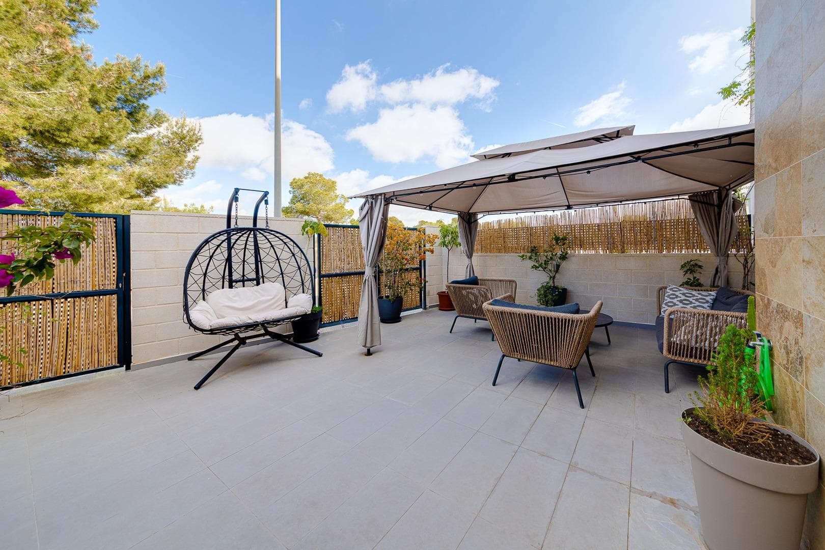 For sale a very spacious semi-detached villa with a modern design in Las Filipinas, one of the most demanded areas of Orihuela Costa. Located in the prestigious golf area of Villamartín, this magnificent property perfectly combines contemporary design, comfort, privacy, and quality of life. It has been designed for those who wish to enjoy the Mediterranean climate all year round, surrounded by tranquility, nature, and all essential services just a few minutes away. The property was built in 2021 and offers 134 m² of built area and 89 m² of usable living space, carefully distributed to provide bright, spacious, and functional rooms. From the very first moment, its modern architecture, contemporary finishes, and the pleasant sense of space throughout the home stand out. Upon entering the property, you are welcomed by a large private terrace, ideal for enjoying outdoor breakfasts, relaxing moments, and sunny afternoons during most of the year. Inside, the heart of the home is its spectacular open-plan living and dining area with a contemporary-style kitchen. This bright and airy space has been designed to encourage family living and social gatherings. While cooking, conversations, laughter, and unforgettable moments naturally unfold, creating a warm and inviting atmosphere. The seamless integration of the living room, dining area, and kitchen provides a perfect balance of space, functionality, and modern living. On the ground floor, there is also a fully equipped bathroom with a walk-in shower, offering convenience for both everyday family use and visiting guests. In addition, a discreet laundry area has been cleverly integrated beneath the staircase, maximizing the available space. On the upper floor, you will find three spacious bedrooms designed to provide maximum comfort and privacy. The property features three elegant bathrooms, two of which are en-suite, offering additional convenience for the owners. Large windows allow abundant natural light to flow into the property throughout the day, creating warm and welcoming spaces connected to the surrounding environment. From the terraces, you can enjoy pleasant views of the green areas, the communal spaces, and, in the distance, the blue waters of the Mediterranean Sea on the horizon. One of the property's greatest attractions is its privileged natural setting. Directly in front of the home lies a large protected green area, providing a unique sense of openness, privacy, and connection with nature. The property also features inviting terraces and a fantastic private solarium where you can relax, sunbathe, or enjoy outdoor dining. From this elevated space, you can take in open views that convey a true sense of wellbeing, peace, and quality of life. The southeast orientation is one of the most desirable features of this home. It allows residents to enjoy sunlight for much of the day, while the pleasant Mediterranean breeze naturally refreshes the living spaces, creating an exceptional atmosphere throughout the year. The property is sold almost fully furnished and equipped with appliances, ready to move into. Only certain custom-made furniture, decorative items, paintings, and the owners' personal belongings are excluded from the sale. The residential complex offers an excellent quality of life thanks to its beautifully maintained communal areas. Residents can enjoy a large communal swimming pool surrounded by landscaped gardens, perfect for walking, relaxing, exercising, or simply admiring the spectacular sunrises and sunsets that characterize the Costa Blanca. The location is another major advantage. Within just a few minutes, you will find supermarkets, restaurants, cafés, shopping centres, pharmacies, international schools, and all the services needed for everyday living. The renowned beaches of Orihuela Costa are approximately 15 minutes away by car, while several internationally recognised golf courses are located just a short distance from the property.