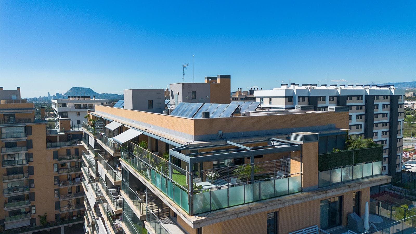 Imagine waking up every morning to the blue of the Mediterranean on the horizon and sunlight flooding every corner of your home. Spectacular ninth-floor penthouse, located in the prestigious Residencial San Juan, in the exclusive PAU 5 area on Avenida Maestro José Garberí. This is not just a home; it is a sanctuary of peace and light in one of Alicante’s most coveted and exclusive areas. Thanks to its south-facing orientation, this property is a natural light magnet. A fully exterior home designed to maximize natural ventilation and brightness all year round. Access to the apartment is through a private landing exclusive to this unit, allowing you to use it as a practical space for shoes or small items. The home features 3 spacious bedrooms and 2 full bathrooms. The master bedroom has an en-suite bathroom for maximum privacy, while the second bathroom serves the rest of the house. The independent, fully equipped kitchen has access to a gallery with a laundry area. A large, welcoming living-dining room naturally flows into the crown jewel: a spectacular 105m2 L-shaped terrace. The terrace offers unobstructed views with the sea as a backdrop. It is designed for enjoyment, featuring a chill-out area for sunsets, a barbecue area for unforgettable dinners, a practical storage room, and a jacuzzi to relax while admiring the Mediterranean. For your comfort, the terrace also has fully automatic awnings, allowing you to enjoy it even on the hottest summer days. Living in Residencial San Juan means having a private club at your feet. The gated community boasts top-level facilities, including a gym, paddle tennis courts, football and basketball courts, swimming pool with green areas and changing rooms, a playground, and an exclusive community room for your special events. Just 700 meters from Playa de San Juan, you will be surrounded by all PAU 5 services and perfectly connected to Alicante city center. A parking space is included in the price, a guaranteed value in this area. Whether as a permanent residence, a vacation getaway, or a high-yield investment, this penthouse represents a unique opportunity that rarely stays on the market. Be the first to visit this sky-high paradise!