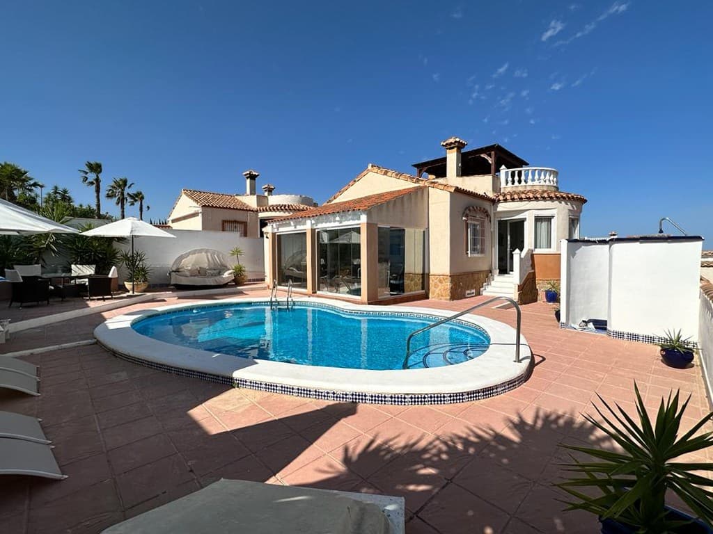 Discover a level of luxury that you will not find anywhere else with this exquisite, detached Mediterranean-style villa in the highly sought-after Lake view Mansions Residential complex. This prestigious home is a statement of sophistication, offering the ultimate in high-end living. The property is situated within the picturesque landscape at the gateway to the protected Sierra Escalona, close to San Miguel de Salinas. This elegantly updated vacation residence has been remodelled to the highest standards. The property is situated on a private plot of 423 m². This Mediterranean-style home was constructed in 2003 and is situated in the tranquil residential community of Lake View Mansions. The property is conveniently located just a 5-minute drive from the town of San Miguel de Salinas. From the moment guests step inside, you are offered a seamless blend of elegance and comfort. Every detail has created an ambiance of refined elegance, ensuring an impeccable flow of space. The modern layout enhances the sense of grandeur, leading seamlessly from one beautifully designed space to another.The property's living and dining area is finished to an exceptional standard and are flooded with natural light from expansive windows that offer stunning views of the private grounds and surrounding countryside. The property features premium porcelain flooring, bespoke lighting, and elegant décor, creating an atmosphere of sheer indulgence.The kitchen has been designed to prioritize both functionality and aesthetic appeal, making this space as practical as it is impressive. Each of the four bedrooms has been designed to provide a private retreat for maximum comfort. The master suite is a sanctuary of relaxation, complete with a private dressing room and bathroom with walk-in shower. The additional bedrooms are equally inviting, offering space and tranquility and en-suite facilities.Step outside and enter your very own luxurious haven. The meticulously landscaped grounds extend to a pristine private pool, providing an idyllic setting for both relaxation and entertainment. Whether you are sunbathing on the Mediterranean terrace or dining al fresco under the stars, this outdoor space has been designed for those who appreciate the finer things in life. The upper level features a terrace with panoramic views and a spacious solarium, complete with a full-size jacuzzi and a gazebo, which offers an elevated retreat in one of the highest points of the coast. This area offers stunning views of the sea, the saltwater lagoon and the mountains. The front garden, which allows vehicle access, is paved for ease of maintenance. The property comprises a swimming pool, a pool-bar space and a lounge area, making it ideal for entertaining in the Mediterranean sunshine. The pool area, equipped with a shower and ample seating, fosters a perfect holiday atmosphere for you and your family. This property is an excellent choice for a family vacation home under the Spanish sun.