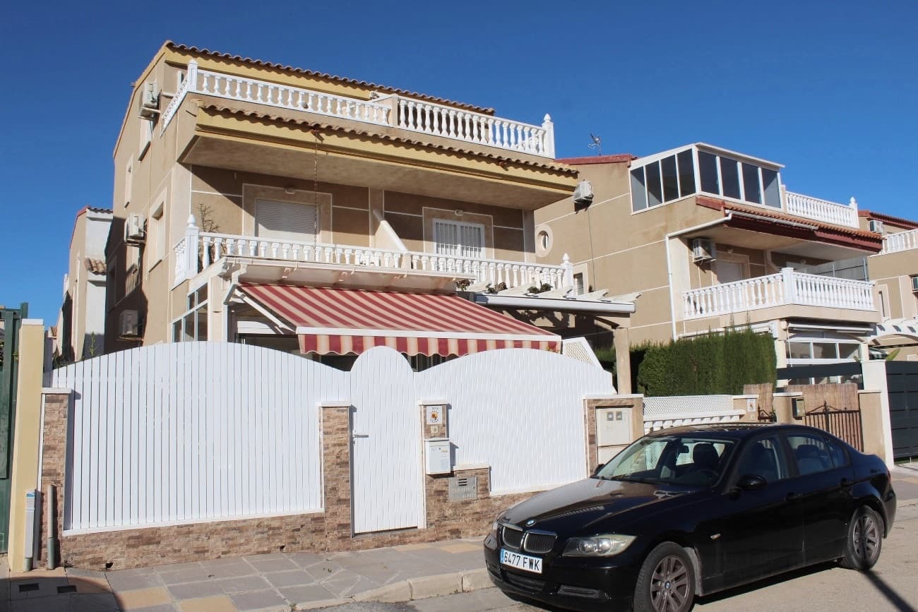 This sunny south-west facing semi-detached Mediterranean-style home is ideally located on a quiet, low-density street in Torre de la Horadada only 700 metres from the sandy beaches.Set in a less built-up and more peaceful area than many neighbouring coastal towns, the property offers a relaxed Mediterranean lifestyle while remaining close to all essential services. Unlike many nearby developments, this home benefits from no community fees, making it ideal for both permanent living and low-maintenance holiday ownership.The property is arranged over several levels and features 3/4 bedrooms and 3 bathrooms, all bedrooms with built-in wardrobes and air conditioning throughout. On the ground floor, there is a spacious and bright open-plan lounge with air conditioning and a gas fireplace, providing year-round comfort. The kitchen is separate and enclosed, offering practical everyday living. This level also has a guest bathroom with walk-in shwoer, a useful storage room which has been converted into a spacious downstairs bedroom with a large wardrobe. The living area opens onto a glassed-in sunny terrace, perfect for enjoying the sun while offering shelter during cooler months.An open staircase leads to the first floor, which comprises two bedrooms and a family bathroom with bathtub, ideal for guests or family living. The top floor is dedicated to a large main bedroom with a spacious en-suite bathroom with shower. From this bedroom, there is direct access to a large private roof terrace, offering sea views — an ideal space for sunbathing, relaxing, or enjoying evening sunsets.Externally, the living spaces flow seamlessly onto a large wraparound terrace with a south-west orientation, ensuring sunshine throughout the day — perfect for outdoor dining, entertaining, or simply relaxing.Torre de la Horadada is renowned for its traditional Spanish character, marina, palm-lined promenades, and long sandy beaches, while offering a full range of restaurants, cafés, shops, supermarkets, medical services, and weekly markets. The nearby town of Pilar de la Horadada, just 5 minutes by car, provides banks, schools, sports facilities, and healthcare for convenient year-round living.For broader shopping and leisure, Orihuela Costa is only 10–15 minutes away, featuring La Zenia Boulevard shopping centre with 150 shopss, international schools, and top golf courses including Lo Romero, Villamartín, Las Ramblas, Campoamor and Las Colinas. San Pedro del Pinatar, around 10 minutes by car, offers marinas, shopping centres, natural parks, salt lakes, and the famous therapeutic mud baths.Excellent transport links include Murcia International Airport (35 minutes) and Alicante Airport (55 minutes), with easy access to the AP-7 and N-332. MUST BE SEEN !