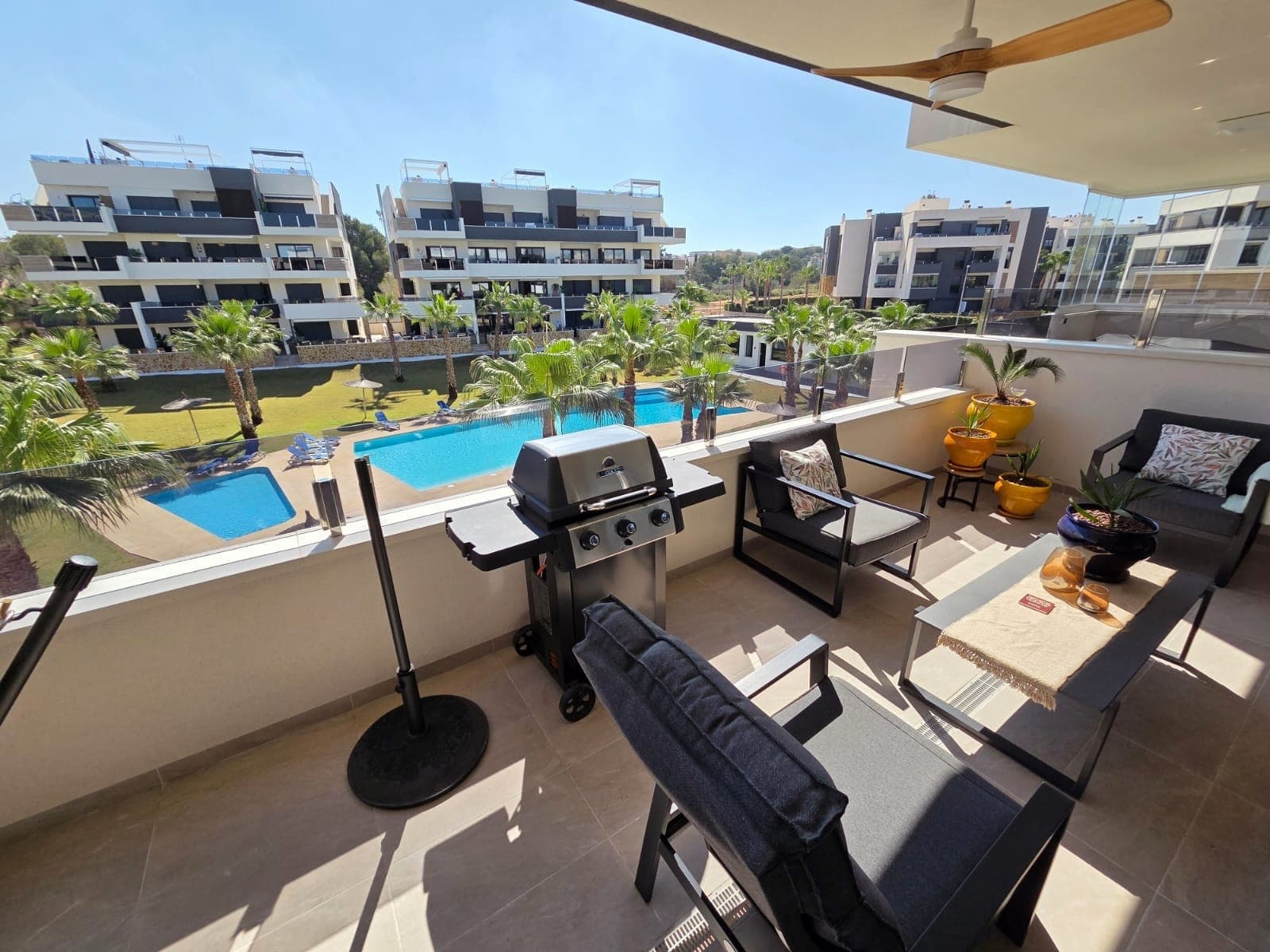 PRICE REDUCED FOR A QUICK SALE !! Luxury apartment for sale in the Spa Resort Amanecer facing the community pool, located in the sought-after area of Los Altos in Orihuela Costa. Completed in 2024, this stylish and contemporary property offers an excellent opportunity as a holiday home, permanent residence or investment with strong rental potential.The beautiful apartment features a bright open-plan lounge, kitchen and dining area designed to maximize space and natural light. Large windows create a light and airy atmosphere and open directly onto a spacious 29 m2 private terrace, offering a seamless indoor-outdoor lifestyle overlooking the community pool. The kitchen is fully fitted with modern appliances and finished in a sleek contemporary style, blending effortlessly into the living space. There are two well-sized bedrooms, both with built-in wardrobes and positioned on the terrace side of the property, along with two modern bathrooms which one of them is en-suite, finished to a high standard. The modern apartment is sold fully-furnished and has a total built area of 81 m², offering a practical and well-balanced layout throughout, its in excellent condition and ready to move in ! One of the standout features is the generous 29 m² private terrace, which enjoys amazing views over the landscaped gardens and communal swimming pool. Its east / south-facing orientation allows for excellent morning and midday sun making it an ideal space for relaxing or eating outdoors. The property is located on the second floor of a building with a lift and includes an underground parking space and a private storage room. It is equipped with air conditioning, an Airzone climate control system, underfloor heating in the bathrooms and electric shutters, ensuring comfort throughout the year. Residents of Amanecer benefit from a resort-style environment, with access to a large communal swimming pool, a children’s pool, a fully equipped gym, as well as a jacuzzi and sauna, all surrounded by beautifully maintained tropical gardens with adapted exterior access for people with reduced mobility. The location is particularly convenient, with restaurants, cafés and supermarkets within 5 min walking distance, and La Zenia Boulevard just a few minutes away by car.For golf enthusiasts, the area offers a great selection of nearby courses, including Villamartín Golf just 5 minutes away, Real Club de Golf Campoamor and Las Ramblas Golf approximately 10 minutes away, and the prestigious Las Colinas Golf & Country Club around 15 minutes from the property. The sandy beaches of Orihuela Costa, such as La Zenia Beach, Playa Flamenca, Cabo Roig and Campoamor, are all within a 10-minute drive.Ideally positioned between two major airports, the property offers excellent connectivity, with Alicante Airport around 40 min and Murcia International Airport 45 minutes away by car.This is a standout opportunity to own a modern new home in one of the most desirable residential complexes on the Costa Blanca. Early viewing is highly recommended to fully appreciate the quality, space and lifestyle this apartment has to offer. MUST BE SEEN !!