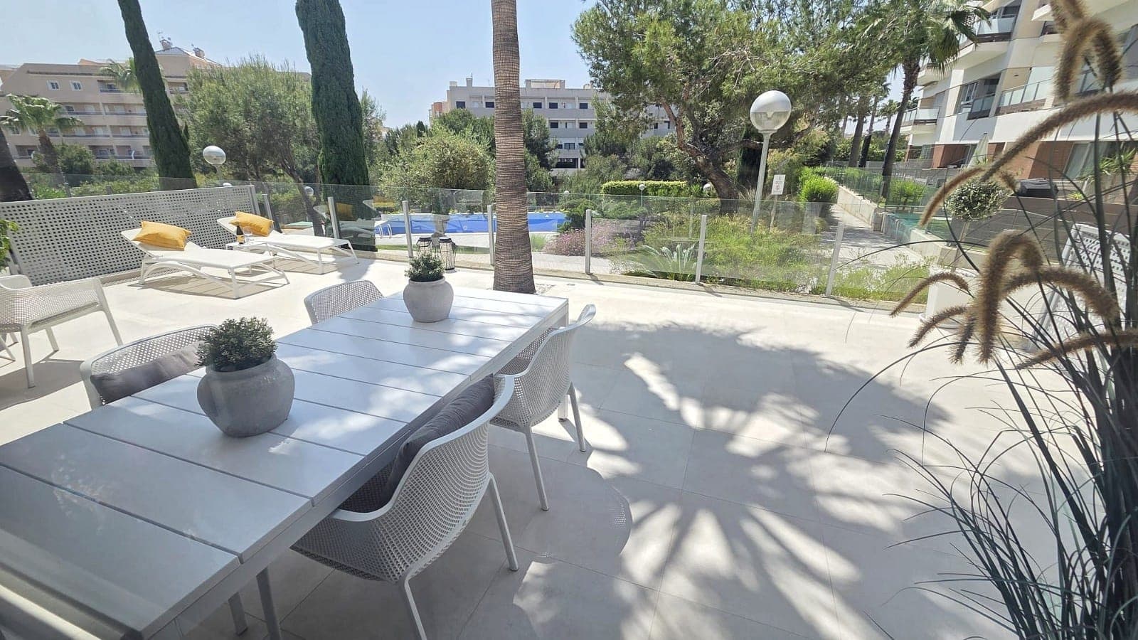 Discover this exceptional 3-bedroom, 2-bathroom ground-floor apartment located in the highly sought-after area of Villamartín – Los Dolses, Orihuela Costa. Immaculately presented and designed with contemporary style, this beautiful 100 m² home offers the perfect blend of comfort, elegance, and convenience.The apartment features a bright and spacious open-plan living and dining area, enhanced by a full glass frontage that floods the space with natural light. The modern kitchen is seamlessly integrated and complemented by a practical seperated Laundry - utility room. The master bedroom includes an en-suite bathroom with a walk-in shower, while all bedrooms benefit from built-in wardrobes.Step outside to enjoy a generous 52 m² south-west facing tiled terrace, offering lovely views over the landscaped gardens and communal pool, along with a subtle glimpse of the sea. The property also boasts a 26 m² private rear garden perfect for storage. Both outdoor spaces provide direct access to two separate communal swimming pool areas, creating a perfect setting for relaxation and outdoor living in the sun.This property is sold fully furnished and equipped to a high standard, including central air conditioning (hot and cold), mosquito nets, alarm system, internet connection, private dedicated parking in the community, and an external storage room on the roof terrace —ensuring both luxury and practicality.Situated within the secure gated community of El Mirador de Villamartín, the apartment is ideally located just a 5-minute walk from supermarkets, restaurants, and bars. A short 5-minute drive brings you to Zenia Boulevard, one of the largest shopping centres in the region, as well as the beautiful sandy beaches of Orihuela Costa, including La Zenia and Playa Flamenca. Golf enthusiasts will appreciate the proximity to four renowned golf courses: Villamartín, Campoamor, Las Ramblas, and Las Colinas.Orihuela Costa, located on the Costa Blanca South, is celebrated for its stunning coastline, vibrant atmosphere, and excellent amenities. Whether you're seeking a permanent residence, holiday home, or investment opportunity, this property offers an outstanding lifestyle in one of Spain’s most desirable coastal areas.  The properties annual running costs are, community fees of €1704 per year and council tax (IBI) of €406 per year. Viewing is highly recommended !!
