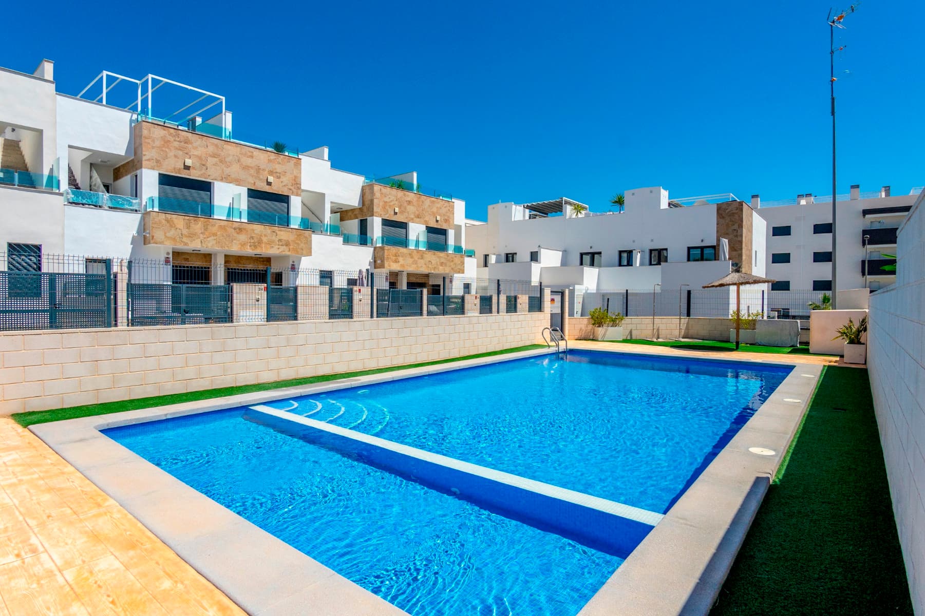 Located in the highly sought-after area of Villamartín, this beautifully presented Triplex house offers an exceptional blend of contemporary design, comfort, and Mediterranean living. Situated in one of Orihuela Costa's most desirable residential areas, the property enjoys a peaceful setting while remaining close to golf courses, beaches, shopping centres, and all essential amenities.Built in 2021 and maintained to an excellent standard, this stylish home boasts 101m² construction surface, 34 m2 south/west facing private garden, a 31m2 solarium and has been thoughtfully designed to maximize natural light, space, and functionality throughout.Upon arrival, you are welcomed by a spacious private terrace, providing the perfect setting for al fresco dining, relaxing in the sunshine, or entertaining family and friends in the afternoon sun. Inside, the heart of the home is the bright and spacious open-plan living and dining area, seamlessly connected to a contemporary fully fitted kitchen. Designed for modern living, this elegant space offers an ideal environment for both everyday comfort and social gatherings, with large windows flooding the interior with natural light and creating a wonderful sense of openness. The ground floor also features a stylish guest bathroom with a walk-in shower, along with a practical laundry area discreetly incorporated beneath the staircase.The first floor offers two generously sized bedrooms with one bathroom, one of them benefits from their own en-suite bathroom, while the third master bedroom on the second floor with en-suite bathroom has access to a nice little terrace overlooking the beautiful nature land in front of them, designed for comfort and privacy, providing convenience for both residents and guests.One of the standout features of this property is its superb outdoor living space. Several terraces and a fantastic 31 m2 private solarium offer the perfect opportunity to enjoy the Mediterranean climate throughout the year. Whether relaxing with a morning coffee, sunbathing, or enjoying evening drinks while watching the sunset, these outdoor areas provide an exceptional extension of the living space. From the upper levels, pleasant open views stretch across the surrounding green areas towards the Mediterranean Sea in the distance.Adding to the property's appeal is the large protected green area located directly in front of the house, creating a rare sense of privacy, tranquillity, and connection with nature. This open outlook enhances the feeling of space and ensures an attractive setting for years to come. The property is being sold almost fully furnished and includes white goods, allowing the new owners to move straight in and start enjoying their new home. Residents of this attractive community enjoy access to a nice maintained communal area with a large swimming pool, offering the perfect place to relax, socialise, or enjoy the wonderful Costa Blanca climate with over 300 sunny days a year !The location is equally impressive. The popular Villamartin Plaza is only 10 min walk distance away, where you will find supermarkets, restaurants, cafés, shopping facilities, pharmacies, international schools, and a wide range of everyday services. 4 prestigious golf courses are nearby ( Villamartin, Campoamor, Las Ramblas, Las Colinas ), while the sunny beaches of Orihuela Costa can be reached in 10 minutes by car as well as the popular Zenia Boulevard Shopping Centre with 160 shops, Alicante and Murcia airports are also easily accessible by A-7 or N332 within 45 min drive.This is a fantastic opportunity to acquire a modern, spacious, and beautifully maintained home in one of the most desirable areas of Orihuela Costa. Whether you are looking for a permanent residence, a holiday retreat, or a sound investment property, this exceptional house offers everything needed to enjoy the very best of the Mediterranean lifestyle !