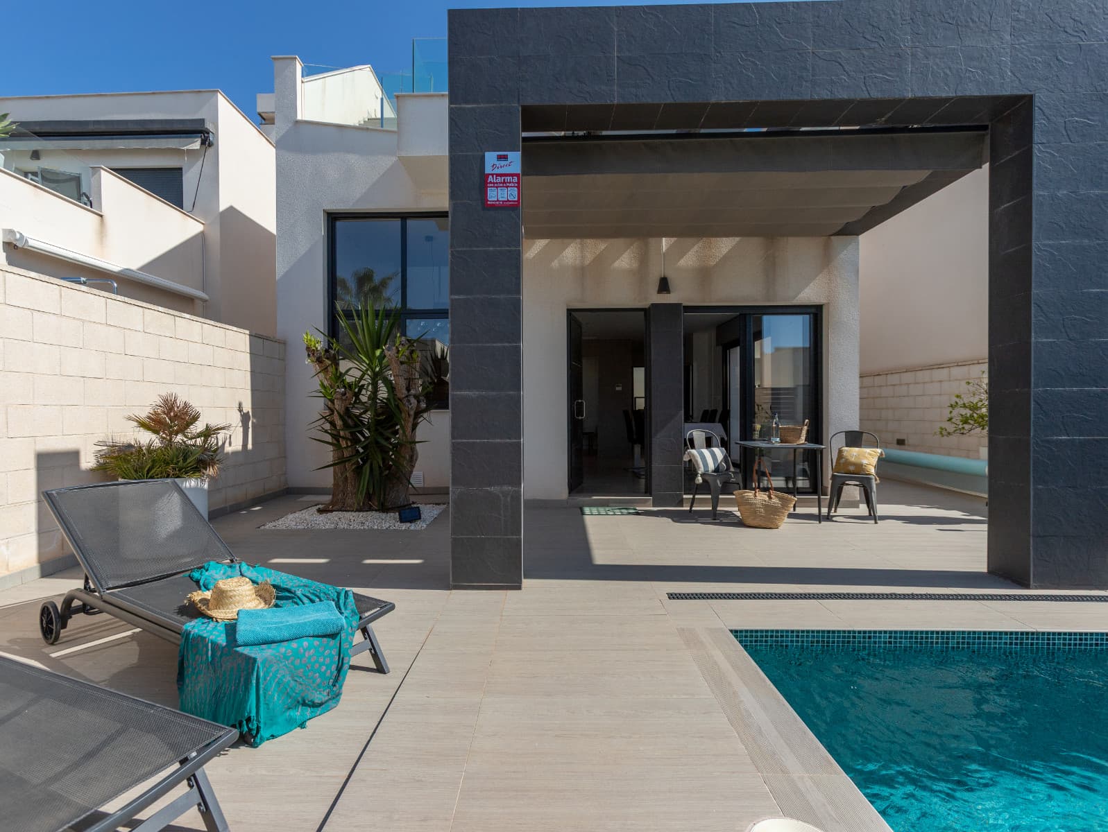 Have you always dreamed of your own villa under the Spanish sun? Here is an excellent opportunity to acquire your own, modern villa with its own recently retiled swimming pool. There is space for a car in your own yard and along the inner street of a safe, gated community.Downstairs there is a spacious living room and dining area, the bright living room has double height. The kitchen is modern and well-equipped, with a practical utility room at the back. Downstairs there is also one bedroom with en-suite bathroom and separate toilet.Upstairs there is a master bedroom with its own en-suite bathroom and another room with plenty of wardrobe space and a sofa bed. The master bedroom has a south-facing balcony, from which there are stairs to your own roof terrace.The services of Rojales are close by, the supermarket Consum is only a couple of hundred meters away, and there are also several restaurants within walking distance. The popular El Recorral park is just a half hour walk away, and La Marquesa golf course is less than a 10 minute drive away. The nearest sandy beaches in El Moncayo are about a 10 minute drive away. The popular Sunday Lemon Tree market is only about 5 km away.Community fees only 241,68€ per year