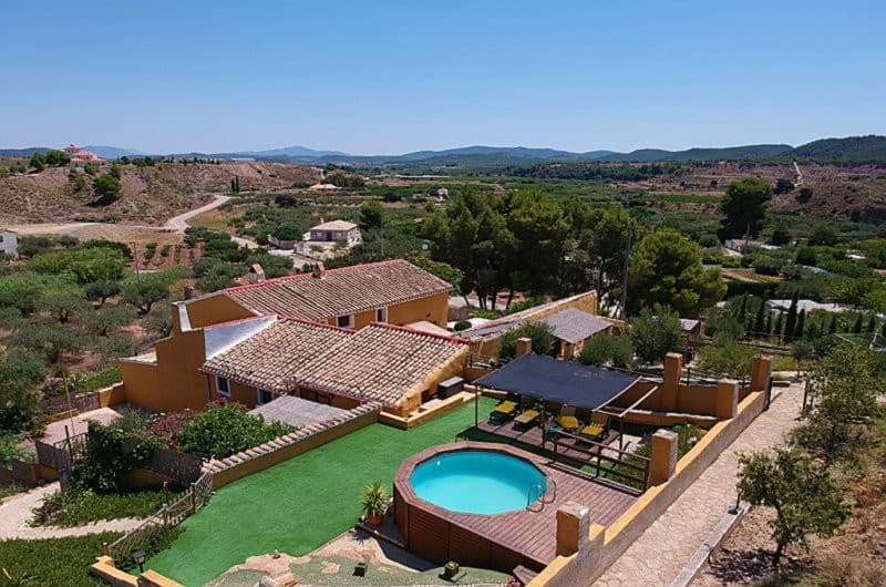 A beautifully renovated, 18th century Spanish farmhouse with an annexe / guest house and three cottages with holiday / long-term letting income potential. This property has a total of 10 bedrooms, 8 bathrooms, and a self-contained annexe with the farmhouse.The estate is arranged into four separate self-contained units enabling the buyer to use the property in a number of ways including a luxury home, a rental / holiday business or a combination of both.There are substantial grounds, 7850 square metres of land with olive trees and terraced areas, electrically powered entrance gate and manual back gate to the land.There is also planning permission (details available) for an additional building to be built on the terrace areas, giving potential for expansion.Log cabins or Yurts are also a possibility.FarmhouseThe main farmhouse offers approximately 230 square metres of internal space refurbished in a traditional rustic style, retaining many original features, including wooden beams and a traditional fireplace Ground FloorSitting Room (7.16 x 3.67m) with feature fireplace fitted with wood burner and alcoves either side. Kitchen (5.4 x 3.71m) fitted with base and wall units, plumbing for a washing machine and dishwasher, oven and gas hob.Study/Bedroom 5 (3.65 x 3.63m) currently used as a study but could be a double / twin bedroom.Family Bathroom / Storeroom with WC and pedestal wash hand basin.First FloorMaster Bedroom (4.14 x 3.74m) Double / Twin room with ensuite comprising shower cubicle, basin and WC.Bedroom 2 (3.8 x 3.8m) double / twin room with shower, pedestal basin and separate WC.Bedroom 3 (3.69 x 3.64m) double / twin roomBedroom 4 (2.89 x 3.71m) double / twin roomFamily shower room comprising walk in shower, WC and pedestal wash hand basin.Farmhouse Annexe / Guest CottageOne-bedroom self-contained cottage, located in the farmhouse private courtyard.Kitchen / Lounge (6.25 x 3.62m) ground floor with stairs to:Open Mezzanine (4.83 x 3.65m) double bedroom with shower & WC. OutsideThe farmhouse and annexe private courtyard (90 square metres) is tiled and the farmhouse back door and annexe porch entrance adjoin it. There is an outside bar / kitchen. This leads onto an Astra turf area, with a log storage room where the gas hot water heater is located.3 Self-Contained CottagesCottage (RC)One bedroom cottage with self-contained private courtyard / garden with BBQ, seating area and a shaded porch.WIFI enabled, fully furnished.The property consists of a kitchen / breakfast area (5.39 x 1.73m) with electric oven and hob, washing machine, microwave, fridge, freezer, Nespresso coffee machine, storage units and wall units.The lounge (2.64 x 2.71m) has a cosy seating area with TV and internet points.Double bedroom (5 X 3.5m) with walk-in shower, basin and WC.Cottage 2 (OTC)Ground floor two-bedroom cottage with private garden / courtyard with BBQ and shaded seating area. WIFI enabled, fully furnished.Kitchen / diner / lounge (9.65 x 3.78m) open plan space.Kitchen comprises a range of storage units, oven, gas hob, washing machine, fridge/freezer, microwave and Nespresso coffee machine.The seating lounge area has a fireplace feature with TV and internet points.Bedroom one (3.65 x 3.10m) double room with wardrobes.Bedroom two (3.65 x 3.65) a double but with two single beds, wardrobes.The family shower room (3 x 3m) comprising walk in shower, basin and WC.Cottage 3 (GVC)First floor two-bedroom cottage with private garden courtyard with BBQ and shaded seating area.WIFI enabled, fully furnished.Kitchen / diner / lounge (7.69 x 3.84m) open plan space.Kitchen comprises a range of storage units, Extractor fan, oven, gas hob, washing machine, fridge / freezer, microwave and Nespresso coffee machine.The seating lounge area is separated by a breakfast bar with TV and internet points.Bedroom one (3.89 x 3.75m) double room with en suite shower, basin and wardrobes.Bedroom two (3.78 x 3.24m) a double / twin room with wardrobes.The family shower room (3 x 3m) comprises walk in shower, basin and WC. OTC and GVC are currently two cottages with their own private access which are divided by a locked door to a staircase which could easily be returned to a four-bedroom cottage.  Outside Pool and Sun terraceThe communal pool area has a salt water 4 metre diameter round, above ground pool, this area is Astra turfed with a shaded area with sun loungers.An in-ground pool could be installed if desired (planning permission has been obtained but would need to be renewed.)CarparksThe main carpark is accessed from the front gate and parks up to six cars. There is an entrance at the back of the property with further parking for four cars. The planning permission for the additional building is included in the sale.