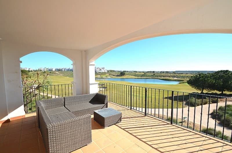 RARE 2 BED 2 BATH - ONLY A LIMITED NUMBER OF THESE APARTMENTS ON HACIENDA RIQUELMEBOASTING SOME OF THE MOST BEAUTIFUL VIEWS TO LA MANGA AND THE MAR MENOR IN THE DISTANCEFRONT LINE GOLFVIEWS OVER ONE OF THE 19 ON RESORT SWIMMING POOLSVERY LARGE ´L´ SHAPED TERRACEPERFECTLY LOCATED FOR EASY ACCESS TO THE ON RESORT AMENITIESBRIGHT AND AIRY SECOND FLOOR APARTMENT LOCATED ON THE GATED COMMUNITY OF HACIENDA RIQUELME GOLF RESORT18 HOLE JACK NIKLAUS DESIGNED GOLF COURSE24 HOUR SECURITYEXTENSIVE COMMUNAL GARDENS19 SWIMMING POOLSSUPERMARKETRESTAURANTBARThis EAST and SOUTH facing apartment is located on Phase 3 of the Resort with open views over the golf course, two of the lakes and one of the 19 swimming pools. Another swimming pool is situated just seconds away.Upon entering the apartment, the fully equipped kitchen is located to the right. It comprises of a range of base units, worktop and wall units with oven, hob, extractor, fridge/freezer and dishwasher. The kitchen leads out to a utility area which has been enclosed with double glazed sliding doors and houses the gas combi boiler and washing machine. With a little imagination, the kitchen could be reconfigured to make the apartment an American style open plan kitchen lounge/diner, with the sink moved to the utility area, overlooking the golf course and lakes.The master bedroom is spacious and has built in wardrobes with ample hanging and drawer space.French doors lead to the very sizeable ´L´ shaped terrace.The master bedroom also benefits from an en suite bathroom, comprising of bath with shower over, vanity unit with surface mounted washhand basin and mirror above, WC and bidet.The shower room comprising of shower cubicle, WC and washhand basin with pedestal is situated between the two bedrooms and benefits from a window.The second bedroom looks over the internal atrium and has built-in wardrobes offering ample hanging and storage space. The dual aspect lounge / diner enjoys views over the swimming pool and the golf course. There are French doors leading to the very large ´L´ shaped terrace which could be enclosed fully or partially providing an area ideal for relaxing, dining or sunbathing.The orientation of the property is perfect for enjoying morning and afternoon sunshine. Visit the GALLERY page of our website to see images of the home improvements that can be carried out. The typical Spanish village of Sucina with its bars, restaurants and church square is just a few minutes away by car.Murcia International airport is located approximately 20 minutes away by car and Alicante airport approximately 1 hour 15 minutes by car.The historic cities of Murcia and Cartagena are both located approximately 40 minutes away by car.Visit the GALLERY on our website to view photographs of places to visit in the local area and beyond.The Costa Calida beaches running along the Mediterranean coastline are only a 20 minute drive away by car.
