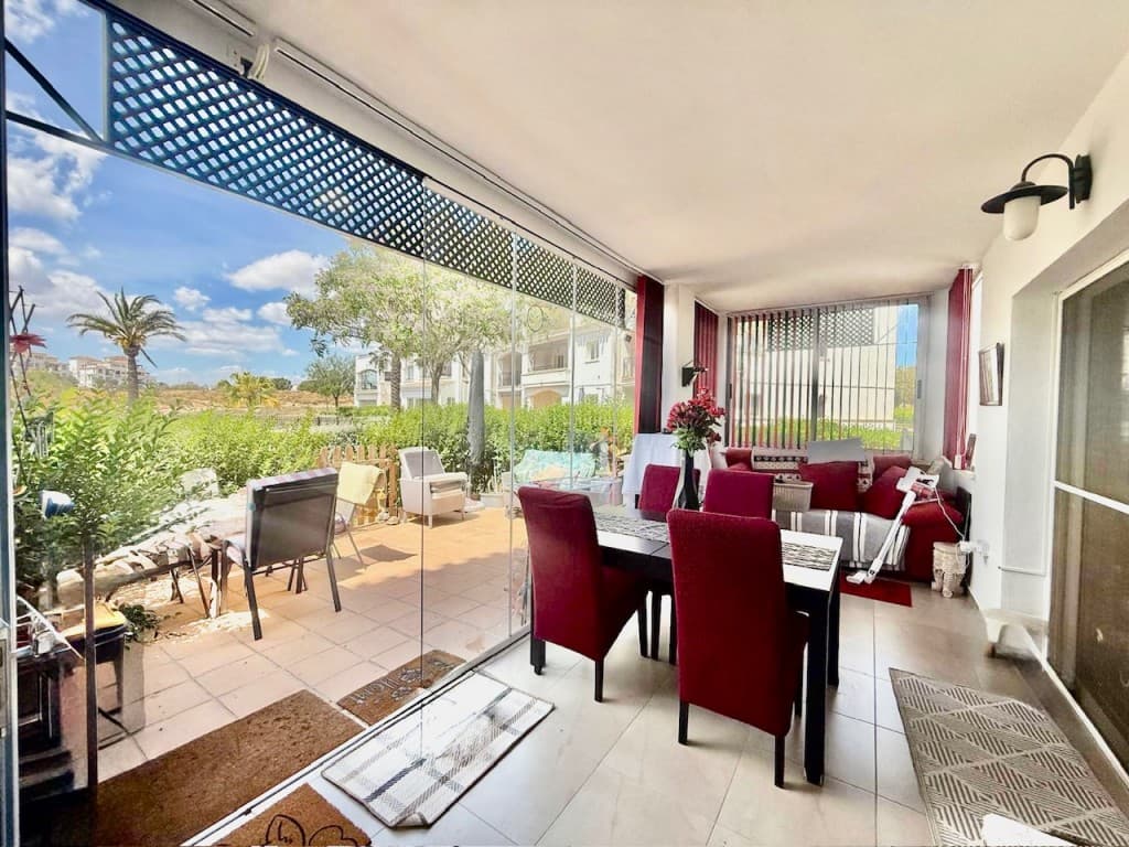 South West facing ground floor golf apartment. &127774; 2 Bed South West Facing Ground Floor Golf Apartment – Hacienda Riquelme Golf ResortA beautifully presented 2-bedroom, 1-bathroom ground floor apartment located in the sought-after Hacienda Riquelme Golf Resort, offering a perfect blend of comfort, sunshine, and resort-style living.This southwest-facing property enjoys a sun-soaked position with lovely views over the communal swimming pool and golf course. The covered terrace with glass curtains provides a versatile additional living or dining area, which seamlessly leads out onto a tiled open terrace—ideal for relaxing outdoors and making the most of the Mediterranean climate.Inside, the bright, spacious lounge - with aircon, benefits from its end position, allowing for an extra window that fills the space with natural light. The apartment is being sold partly furnished, making it ready to enjoy.The property features:Two well-sized bedrooms, both overlooking the beautifully maintained communal gardensAir conditioning in both bedrooms and living roomFitted sliding wardrobesA large walk-in wet room with a window for natural lightAn upgraded white kitchen, extended with additional units for extra storageFull gas central heating throughoutThe tiled outdoor terrace with gated access is a real suntrap—perfect for dining, entertaining, or simply unwinding.&127796; Resort & Location HighlightsSet within a secure gated community with 24-hour security, residents benefit from:On-site restaurant and coffee shopSupermarketPaddle and tennis courtsBeautiful communal pools and landscaped gardensThe nearby Spanish village of Sucina offers a great selection of cafés, restaurants, and everyday amenities.The property is ideally located for exploring the Costa Cálida, with the historic cities of Cartagena and Murcia just 20 minutes away, and Murcia International Airport within easy reach. The beautiful beaches of the Mar Menor are also just a short drive away, offering warm, shallow waters and a perfect setting for relaxing days by the sea.This is an ideal property for a holiday home, rental investment, or permanent residence in the sun.