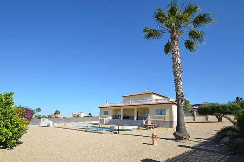 Beautiful 4-Bedroom 2.5 Bathroom Detached Villa situated on huge corner plot with Spectacular Panoramic Views – Campos del Río, MurciaLocated in an elevated, corner position in a highly sought after location in Campos del Río, this exceptional four-bedroom, 2.5 bathroom detached villa offers truly exceptional views across the surrounding countryside and mountains with Murcia city in the distance.Approached via an impressive staircase spanning the full width of the front porch. The property also benefits from convenient level access to the rear.Upon entering the property, you are welcomed into a spacious reception hall featuring an elegant wooden staircase leading to the first floor.The villa has tiled flooring throughout, providing both style and practicality.The hallway leads to a bright and airy dual-aspect lounge, with a feature fireplace and picturesque views over the swimming pool and surrounding landscape. French doors open onto the open terrace which could be enclosed with glass curtains, providing all year round use.The well-appointed kitchen is fitted with appliances including oven, hob, extractor, dishwasher, and fridge freezer, complimented by sleek granite worktops. From here, you can enjoy views over the rear garden. A separate utility area provides additional storage and houses the washing machine.The staircase leads to the landing with a door that opens onto a wraparound terrace, offering 360º vantage points to take in the breathtaking scenery.The remainder of the first floor is dedicated to the master suite which is a standout feature of this property, with direct terrace access, a generous dressing area with floor-to-ceiling wardrobes, and a luxurious en-suite bathroom complete with a corner bath, separate shower, twin basins, bidet, and WC.The ground floor offers three well-proportioned bedrooms and a stylish family bathroom featuring both bath and separate shower, twin basins, bidet, and WC. There is a convenient separate cloakroom with WC and pedestal basin.The property is set on a generous plot with a private swimming pool, external lighting and a number of fruit trees and further benefits from a large double garage with a remote-controlled up-and-over door.This is a rare opportunity to acquire a beautifully presented villa in an enviable position, combining space, privacy, and truly outstanding views.Car journey times are as follows:Village 5 minutesAirport - Murcia International 30 minutesAirport - Alicante International 55 minutesBeaches 50 minutesHospital 20 minutesMurcia City 25 minutesShopping Centres - Nueva Condomina and Thader 30 minutes