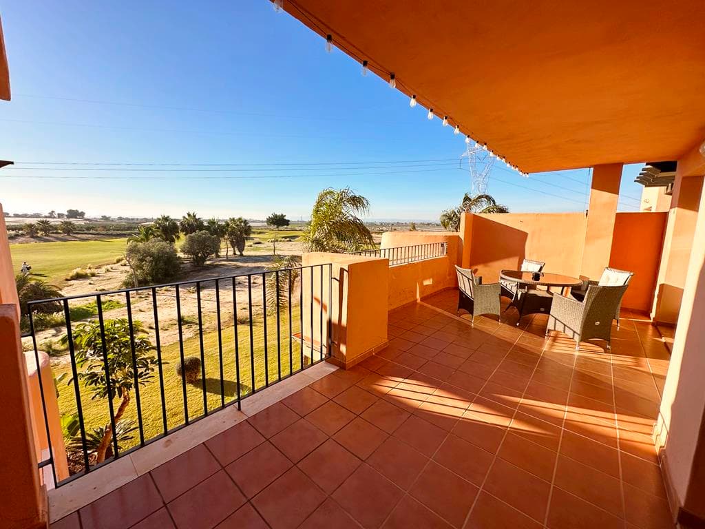 Imagene having a glass of wine on this sunny terrace watching the golf and the beutiful sunsets. We are thrilled to offer this two bedroom two bathroom second floor south west facing Melvin apartment for sale on the beautiful Mar Menor Golf Resort.  The apartment is in a great location with golf views and a short walk to one of the communal swimming pools.  The onsite supermarket and MMGR club with restaurant, padel and mini golf a 5 minutes walk.  You have the onsite 5 star Ona Hotel, clubhouse and a variety of restaurants on the Boulevard just outside the resort. The mar menor beach town of Los Alcazares is a short drive away, Murcia airport 20 minutes and Alicante an hour.  The property has had recently updated aircon and is being sold furnished.  It comes with secure allocated underground parking with lift access to the property on the second floor.You enter the property into the open plan living space with the modern kitchen and breakfast bar and spacious lounge diner.  Patio doors lead to the spacious terrace where you can enjoy wonderful golf views.  There are two double bedrooms both with fitted wardrobes.  The master having an ensuite bathroom and direct access to the main terrace.  You will also find a separate family bathroom.  This is a great price in a fantastic location. Contact us now to book a viewing appointment.