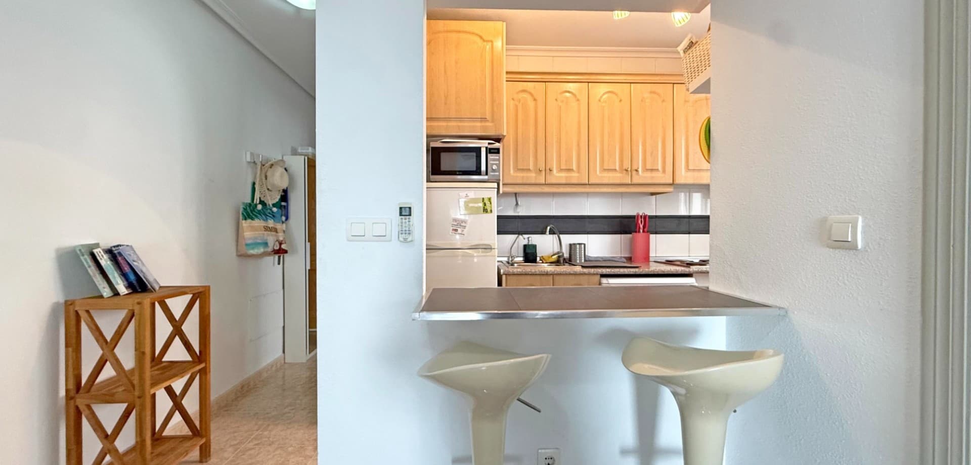 Discover this 5th-floor penthouse apartment in the heart of Torrevieja, ideally located just a short walk from shops, restaurants, and the vibrant promenade. This bright and airy property offers 2 bedrooms, 1 bathroom, and a spacious living area with air conditioning for year-round comfort. There is also a community rooftop.The standout feature is the large, partly glazed-in terrace—perfect for enjoying meals or relaxing while taking in the spectacular panoramic views of the city and the famous pink salt lake.Sold furnished and ready to move in, the apartment also benefits from access to a well-maintained communal pool—an ideal option for both permanent living and holidays.Don't miss this rare opportunity for a top-floor home with unbeatable views and central location!