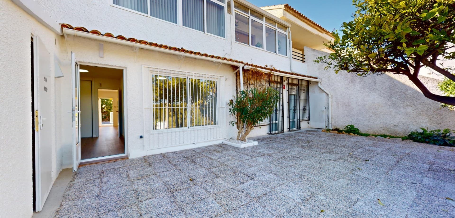 Located in the well-established area of Villamartín, this beautifully renovated ground floor apartment offers a perfect combination of modern design, comfort, and outdoor living, making it an excellent property for sale in Villamartín Orihuela Costa.The property has been fully refurbished, featuring new flooring, updated installations (electricity and plumbing), and a stylish, move-in-ready finish throughout.Inside, the home offers two spacious bedrooms with fitted wardrobes, a modern bathroom with walk-in shower, and a brand-new fully equipped kitchen with appliances including washing machine and dishwasher. The bright living area connects seamlessly to the outdoor spaces, creating a comfortable and functional layout.One of the standout features of this property is its exceptional outdoor space. At the front, you will find a private covered porch with awning, perfect for relaxing in the shade, while at the rear there is a large private terrace, ideal for outdoor dining, entertaining, or enjoying the Mediterranean lifestyle all year round. The property also includes a practical exterior storage cupboard.The apartment is set within a well-maintained residential community surrounded by lush communal gardens, creating a peaceful and green environment.The location is highly convenient, within walking distance to La Rioja commercial centre, Dialprix supermarket, restaurants, and local amenities, and just minutes by car to Villamartín Plaza, Zenia Boulevard, golf courses, and the beaches of Orihuela Costa.This is an ideal home near golf courses and the beaches of Orihuela Costa, and a perfect holiday home or investment property in Costa Blanca South.