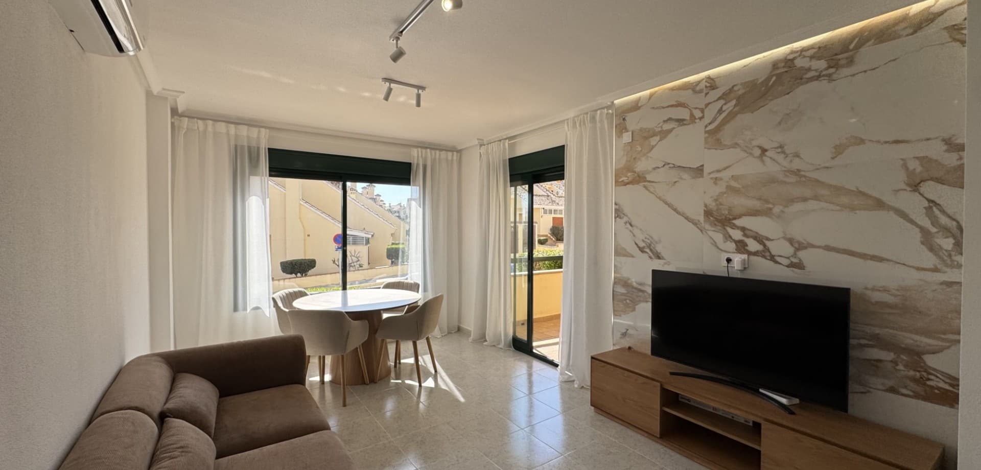 Located in the attractive golf area of Lomas de Campoamor, this fully renovated south-facing apartment offers the perfect blend of comfort and lifestyle. Positioned on an elevated ground floor, it enjoys open views, abundant natural light throughout the day, and a pleasant sense of privacy.The apartment has a built area of 83 m² and features two spacious bedrooms and two modern bathrooms, one of which includes an elegant walk-in shower. The renovation has been carried out with great attention to detail and high-quality materials, including large-format porcelain tiles and natural stone elements, creating a stylish and harmonious interior. The living area is bright and inviting, complemented by a fully equipped kitchen with induction hob and modern appliances.The apartment feels bright and airy thanks to beautiful natural light. Additional features include inverter air conditioning, central gas heating, dual water heaters, good sound insulation, integrated LED lighting, and a security system—ensuring comfort all year round.The property is sold fully furnished with stylish interiors, making it completely turnkey—simply unpack and start enjoying your new home.The community is well maintained, offering green areas and a communal swimming pool. Within walking distance, you will find Las Fuentes commercial center, a lively area with restaurants and cafés that quickly becomes a natural meeting point. For golf enthusiasts, Campoamor Golf Course is just nearby, along with several other well-known courses within easy reach.This is an excellent opportunity to acquire a high-quality, move-in-ready home in one of Costa Blanca’s most sought-after areas—perfect as a permanent residence, holiday home, or investment.