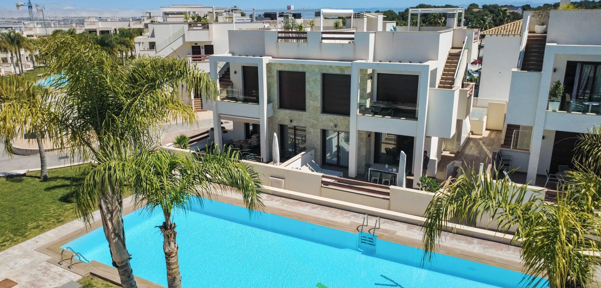 Discover this key-ready 2-bedroom ground floor apartment in Los Balcones, perfectly positioned with direct access to beautiful gardens and two semi-Olympic pools.This bright, modern home offers spacious open-plan living, 2 stylish bathrooms with underfloor heating, and fully furnished interiors with high-end finishes throughout. Enjoy sun all day with two private terraces – a southwest-facing front terrace leading straight to the pool, and a peaceful southeast rear terrace for morning coffee.Built as the show home by Amay, the property includes premium upgrades such as a designer Italian kitchen, powerful air conditioning, electric shutters, alarm system, and private underground parking with storage.Located just minutes from beaches, golf courses, and La Zenia Boulevard, this is the perfect holiday home, investment, or permanent residence on the Costa Blanca.Ready to move in – just bring your suitcase.