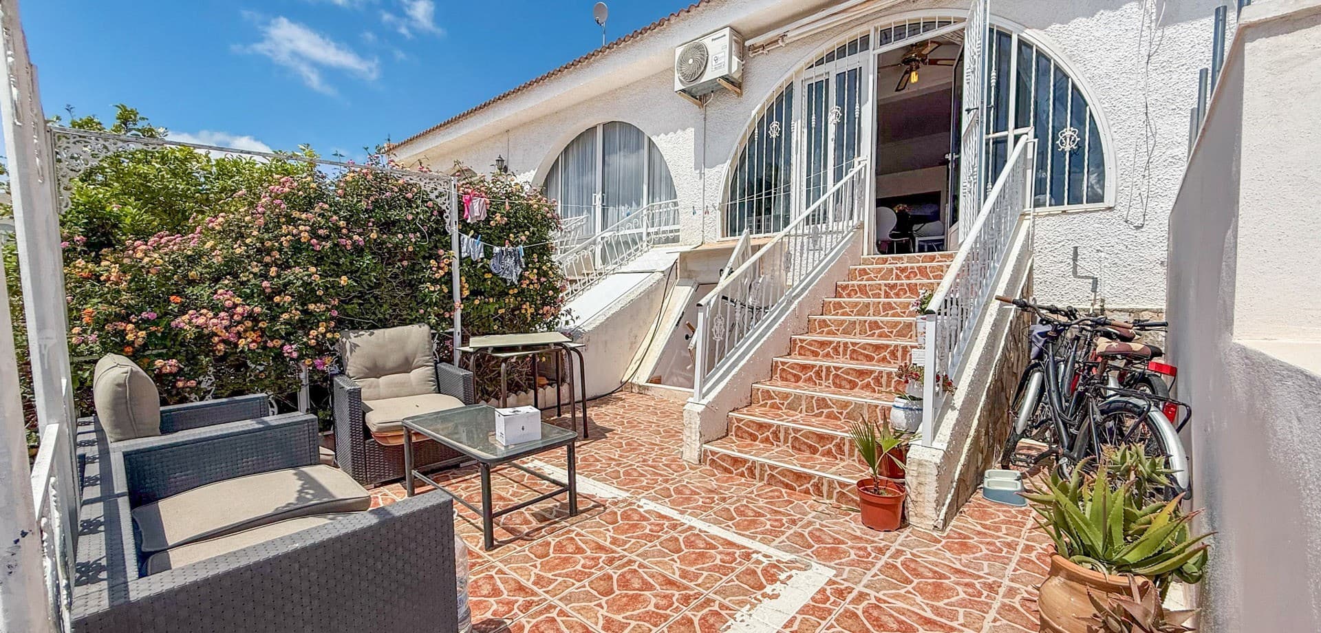 Located in the sought-after residential community of Scandia in Ciudad Quesada, this well-presented townhouse offers a fantastic combination of comfort, flexibility, and outdoor living — ideal as a holiday home, rental investment, or permanent residence in the sun.The ground floor welcomes you with a bright and open-plan layout, featuring a cozy living room seamlessly connected to a well-equipped modern kitchen. This level also includes one bedroom and one bathroom, making it practical for everyday living or hosting guests.Downstairs, the underbuild adds valuable extra space and versatility. Here you’ll find a second bedroom and bathroom, along with an additional living area and a separate kitchen with dining space — perfect for extended family stays, guest accommodation, or even independent living.Step outside and enjoy the south-facing terrace, ideal for soaking up the sun all year round, whether you’re relaxing with a coffee in the morning or entertaining in the evening.The property is situated within a secure gated community, offering peace of mind and access to a beautiful communal pool area, perfect for cooling off during the warm Costa Blanca summers.