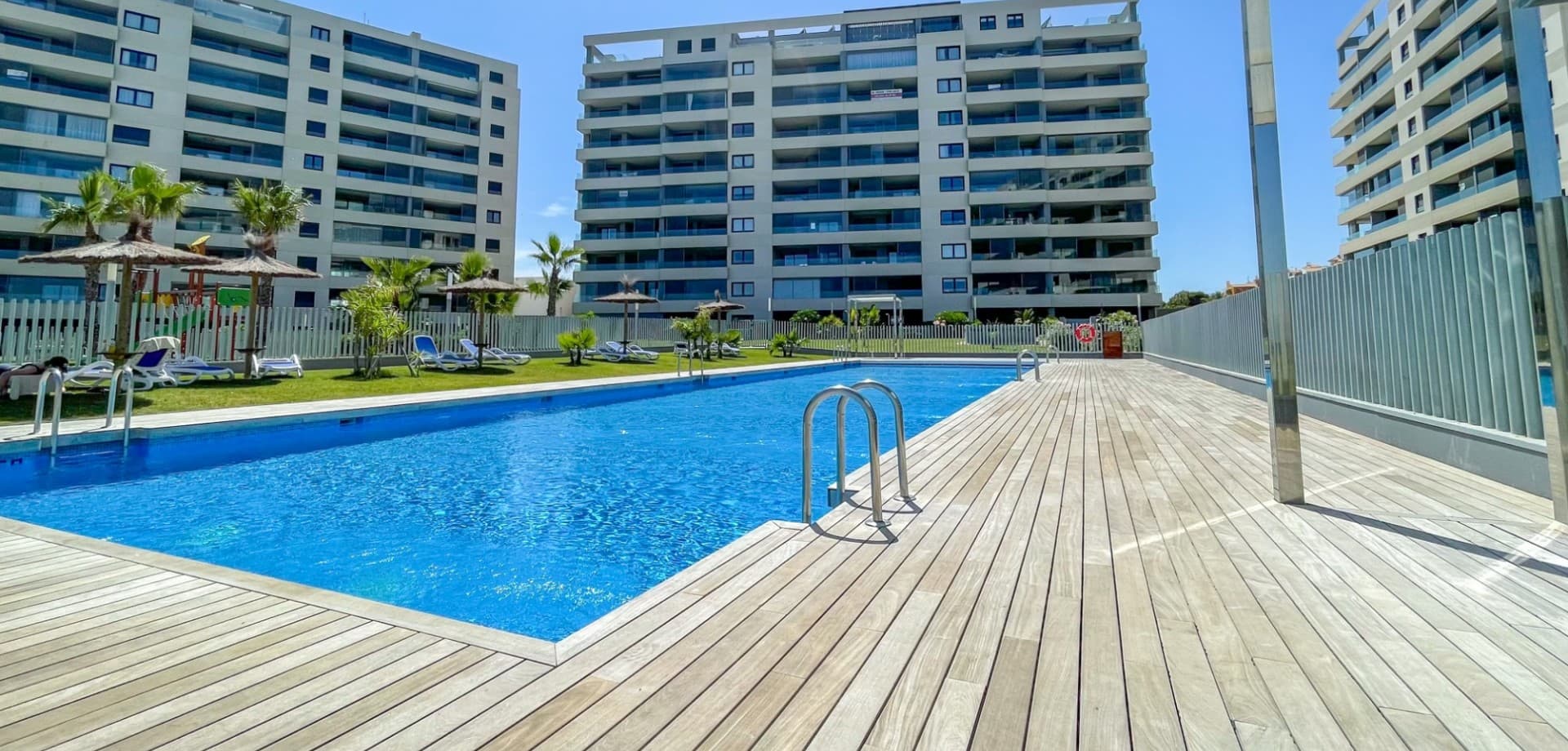 Welcome to this exceptional frontline beach apartment in the exclusive Residencial Posidonia, one of the most prestigious developments in Punta Prima and along the southern Costa Blanca. Combining a privileged seafront location with modern luxury and outstanding communal facilities, this property offers a truly exceptional Mediterranean lifestyle.The apartment enjoys spectacular sea views from all three bedrooms as well as from the main living areas, creating a unique connection with the Mediterranean throughout the home. Large windows flood the property with natural light while perfectly framing the stunning coastal scenery.Offering three spacious bedrooms and two modern bathrooms, the apartment is ideal as a permanent residence, luxury holiday home, or investment property. The bright open-plan living and dining area connects seamlessly with the modern kitchen and the outdoor terraces, creating a spacious and welcoming atmosphere.A particular highlight of the property is its two generous south-facing terraces, where you can enjoy sunshine throughout the day while taking in breathtaking sea views.The property is equipped with central air conditioning throughout and includes a private underground parking space and storage room.Residents enjoy access to three swimming pools, including an infinity pool overlooking the sea, a heated pool with jacuzzi, a children's pool, beautifully landscaped gardens, children's play areas, and 24-hour security.With direct access to the seafront promenade, beaches, restaurants, cafés, and all local amenities, this is a rare opportunity to own a luxury frontline property in one of Punta Prima's most exclusive communities.