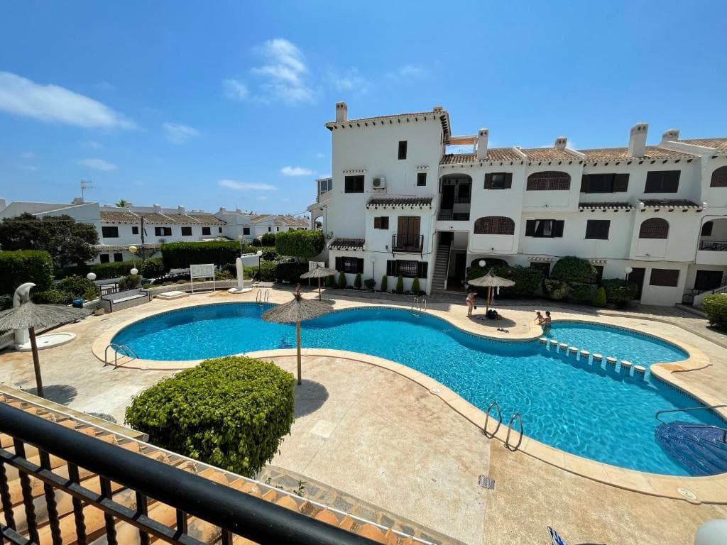 A rare opportunity to acquire this south facing, renovated, very comfortable and fully equipped first floor apartment. It consisting of open plan living room with dinning area, open plan kitchen, 2 double bedrooms, 1 bathroom with a practical walk-in shower. The apartment is in a sought after area of beach side Cabo Roig, Orihuela Costa, situated in a peaceful community of Urbanization Bellavista 5. There is also a secured, gated parking in the complex.The apartment is in a cul-de-sac street, on the first floor and has a large terrace overlooking the community pool. Due to it's south orientation, the property is bathed in natural sunlight throughout the day, creating a warm and inviting atmosphere. Fully furnished and equipped ready to move in! Distance to white sandy beaches of Cabo Roig is 700 meters and all amenities 300 meters, just a short walk along Cabo Roig strip. The renowned Zenia Boulevard is approximately 20 minutes on foot, providing a hub for shopping and entertainment. Villamartin, Las Ramblas, Campoamor and the award winning Las Colinas golf courses are 10 minutes drive with several other golf courses 20 minutes drive, This property presents an exceptional opportunity to embrace a relaxed Mediterranean Beach lifestyle, whether as a permanent residence, holiday getaway, or an investment. The town of Torrevieja, just 5 km drive with it's reach cultural life with music auditorium and concert hall, theater presents another, metropolitan entertainment area practically at the doorstep.
