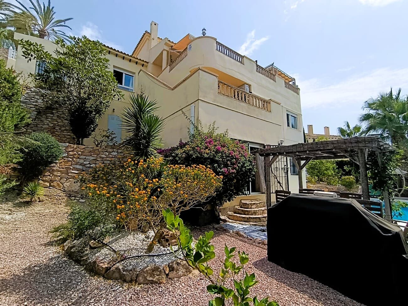   MASSIVE PRICE REDUCTION FOR QUICK SALE -----Our client has reduced the price from €675,000 down to €635,000This property has been priced to sell and believe us when we tell you, you get your monies worth with this Villa. We present to you this Amazing Villa situated in a unique position, built into the side of a Cliff, over looking Las  Ramblas Golf Course, in the Beautiful Costa Blanca region of Orihuela Costa, just minutes from the Gorgeous Beaches. Officially listed as a 4 Bedroom Villa, this unique home offers incredible flexibility, with the potential to accommodate up to 7 bedrooms, with could include a separate apartment. This would ideally suit a family, or those seeking additional space for guests with separate accomodaion on the lower floor, even a potential rental opportunity for Golfers. The Villa was designed and custom built by the current owners 27 years ago,  built into the cliffside, this not only is picturesque but aids in cooling the property in the Hot Summer months, reducing the reliance on Air Conditioning and providing addional warmth in the winter months. Each room offers spectacular views of the Golf Course and Greenery surrounding the Villa. The Villa spans 3 floors plus a mezzanine level from the kitchen area. Please join us as we walk you through each floor, giving you a full appreciation of the villa’s unique design and impressive potential. Garage - WorkshopAs you arrive at the property from the road, you're greeted by a spacious garage complete with an electric car charging point. To the rear of the garage, there’s a  workshop area with its own separate entrance, offering potential additional storage. Entering the Villa - Top Floor LevelUpon entering the villa, you'll find a central staircase that connects all three main levels of the Villa. This entrance point is on the top floor, with the staircase leading down through the second floor and finally to the ground floor, where the swimming pool is located. On the top level, turning left from the entrance takes you into a  fully fitted kitchen. The kitchen features two sets of patio doors, both opening onto expansive terraces, perfect for al fresco dining and entertaining around the built-in BBQ area. From the kitchen, a staircase leads up to the mezzanine level, where you’ll find Bedroom 4, currently used as an office. This area also includes an open space ideal for relaxing. Back in the main hallway, you’ll find a guest WC and a utility room, complete with plumbing for a washing machine and a convenient sink area. The spacious lounge offers an open fireplace and direct access to the terrace through large patio doors. This room is large enough to accommodate a dining area, which presents an exciting opportunity: the current dining room could easily be converted into an additional bedroom (potentially Bedroom 5), giving you even more flexibility in the home’s layout. Expansive Terrace - Top FloorThis Expansive South Facing Terrace is thoughtfully divided into three distinct areas, perfect for both entertaining and everyday relaxation. As you step out from the lounge, you’re greeted by a  seating area, complemented by a winding staircase that leads down to the master bedroom on the lower floor. At the heart of the terrace, a dedicated dining area sits beneath a pergola. The third area features a built in BBQ, perfect for hosting gatherings or simply enjoying the panoramic views of the lush greenery and golf course. 2nd - Middle Floor LevelBack to the Lounge, we enter the staircase, leading down to the 2nd floor, where you will find 3 Bedrooms. The Master Bedroom encorporates a walk in Dressing room and a large Ensuite, offering a full size Bath and a large Walk in Shower. This level has  2 more double Bedrooms with fitted wardrobes and a Bathroom. Ground Floor - Potential Guest ApartmentWe now step down to the Ground floor. As you enter into a large open area, you continue on towards a small kitchen area and seperate bathroom. Also external side door, which leads to the Garden and pool area. Coming back on yourself, you enter another open plan area, with a Bar and Patio doors, which again, lead onto the Garden and Pool area. This entire area could be re designed to create a self contained apartment, with a full kitchen with 2 Bedrooms (Bedroom 6 & 7) along with a Lounge area. Ideal for addional guests or a rental for Golfers/Holiday guests. Swimming Pool area - GardenThis Villa has a beautiful, well maintained Swimming Pool, which the owner tells us, has just been re grouted. The gardens spread down to the Top entrance level, down to the pool and up to the other side of the house into the cliffs.there is a specific sunbathing area at one side of the pool and a dinning area with Pergola at the other side.  The Villa whilst is stand alone and has a Private pool, it also has access to 5 other Communal pools. SpecificsThe Villa has been built, fully Legal, with mains Gas Central heating. Rear Access on the 2nd floor, to the whole house, underneath each floor, for works if required to Electrics, plumbing and more.  The Villa is fully air conditioned The owner informs us he has installed a new Electric Door to the Garage. As a Home owner on Las Ramblas Golf, the current owner informs us that you are given a 10% club house discount and a further discount for the Golf Course.