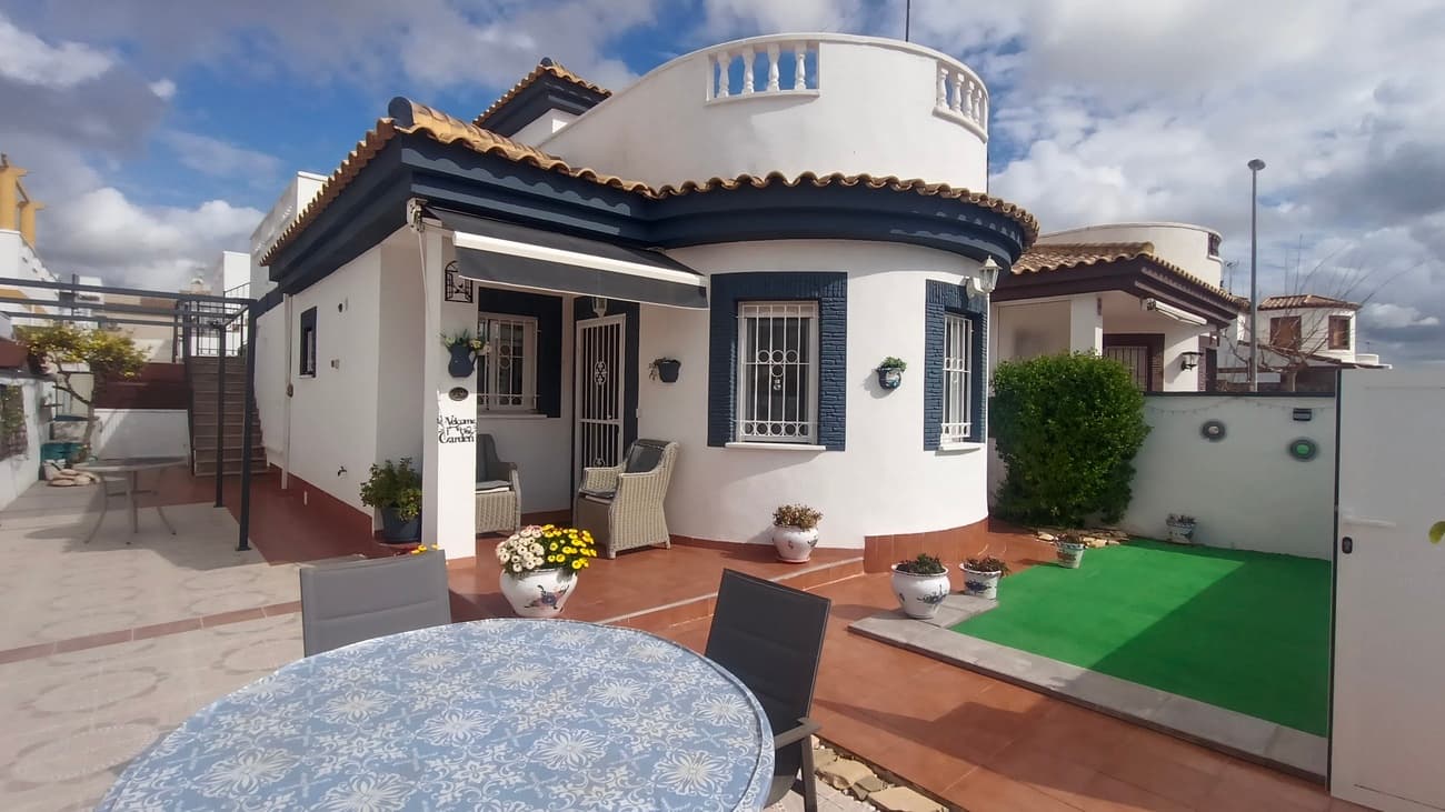 This detached villa in Sucia offers many attractive features. South-facing to enjoy sunshine throughout the day, it is located just a few minutes’ walk from the traditional village, with all local amenities close by.The property is accessed from the street into a terraced garden, which provides several levels and multiple areas to relax, enjoy the sunshine, or dine al fresco. At the rear of the plot there is additional terrace space and useful storage. An external staircase leads to an upper terrace and to a separate annex studio.The main house is entered through a covered porch that opens into a bright, open-plan living room. The space is tastefully furnished with a sofa, armchairs, dining suite, and storage units. From here, the property flows into a fully upgraded kitchen fitted with modern units, a ceramic hob and oven, fridge freezer, and dishwasher.A small hallway leads from the living room to the sleeping accommodation. On the right there is a double bedroom with views to the rear of the property, and on the left a second double bedroom, also overlooking the rear and featuring fitted wardrobes. Both bedrooms are furnished with double beds. The family bathroom is also located off the hallway and includes a shower, WC, and vanity unit.Accessed via the external staircase, the upper level features a separate studio apartment. This bright space has a south-facing window, ceiling fans, a double bed, and fitted wardrobes. It also includes a second bathroom with a shower, WC, and wash hand basin.This property is ideally suited for permanent living or as a holiday home. It is within walking distance of the village and all amenities, and is conveniently located approximately 20 minutes from the coast and the airport.Highly recommended for viewing.