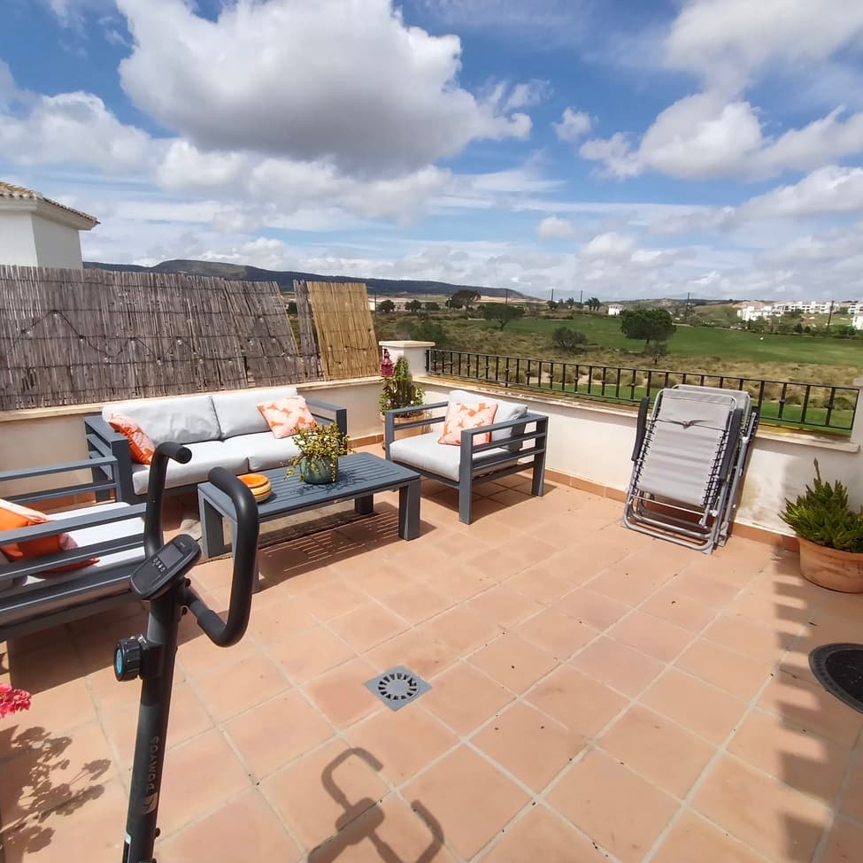 This beautiful penthouse apartment in Hacienda Requelme offers it all. It's light, bright and airy with beautiful, spectacular panoramic views of the golf course and the mountains with large open terrace to enjoy sunshine all day. The apartment is situated in a building with lift  access from underground parking. The lift access takes you straight to the front door of the apartment where you enter into a large open plan living dining room. To the left is a dining area which leads out to the terrace. The terrace is open with views to one side to the mountains and to the golf to enjoy sunshine all day, an ideal place for alfresco living, eating, dining and sunbathing. The dining living area has arched windows throughout to frame the beautiful views. The dining area is adjacent to the sitting area, which is furnished with sofa, TV, dining room table, and it leads into an open-plan kitchen, which has been modernized to a very high standard with a silestone worktop, Scandinavian high-quality kitchen units, and comes with a fridge freezer, cooker, extractor, oven, washing machine. The washing machine is situated in a separate utility area, which leads from the kitchen. The living room has a curved wall feature, which leads to a corridor to the bathroom and bedrooms. To the left is the bathroom, which comes with a bathtub, a window, a vanity unit, a WC, and the hallway then leads to two double bedrooms. The one to the left has double bed, bedside cabinets, fitted wardrobes, ceiling fans, and leads to the back terrace. The one to the right also has double bed, fitted wardrobes, ceiling fans, and leads to the back terrace. Back terrace is covered with fantastic views to the golf and is an ideal place to enjoy the outdoors, an outdoor space. The apartment comes with air conditioning in the living room and bedroom, and it comes with underground parking space with direct lift access to the apartment. The apartment is set in the Avienta Golf Resort, which comes with 24-hour security, 19 swimming pools, sports facilities, tennis, paddle, outdoor gym, outdoor football, basketball area, and a fantastic, beautiful 18-hole golf course with beautiful views and walks to enjoy peace and quiet and wildlife. The apartment is also situated near the town centre, so it is just a one-minute walk to a cafe, a restaurant and supermarket situated on site. Situated just five minutes from the nearest village of Sucina, 20 minutes to the coast, and 20 minutes to the airport, this is the ideal place to to live, to holiday and to rest. Highly recommended for viewing, this apartment comes fully furnished as seen. 