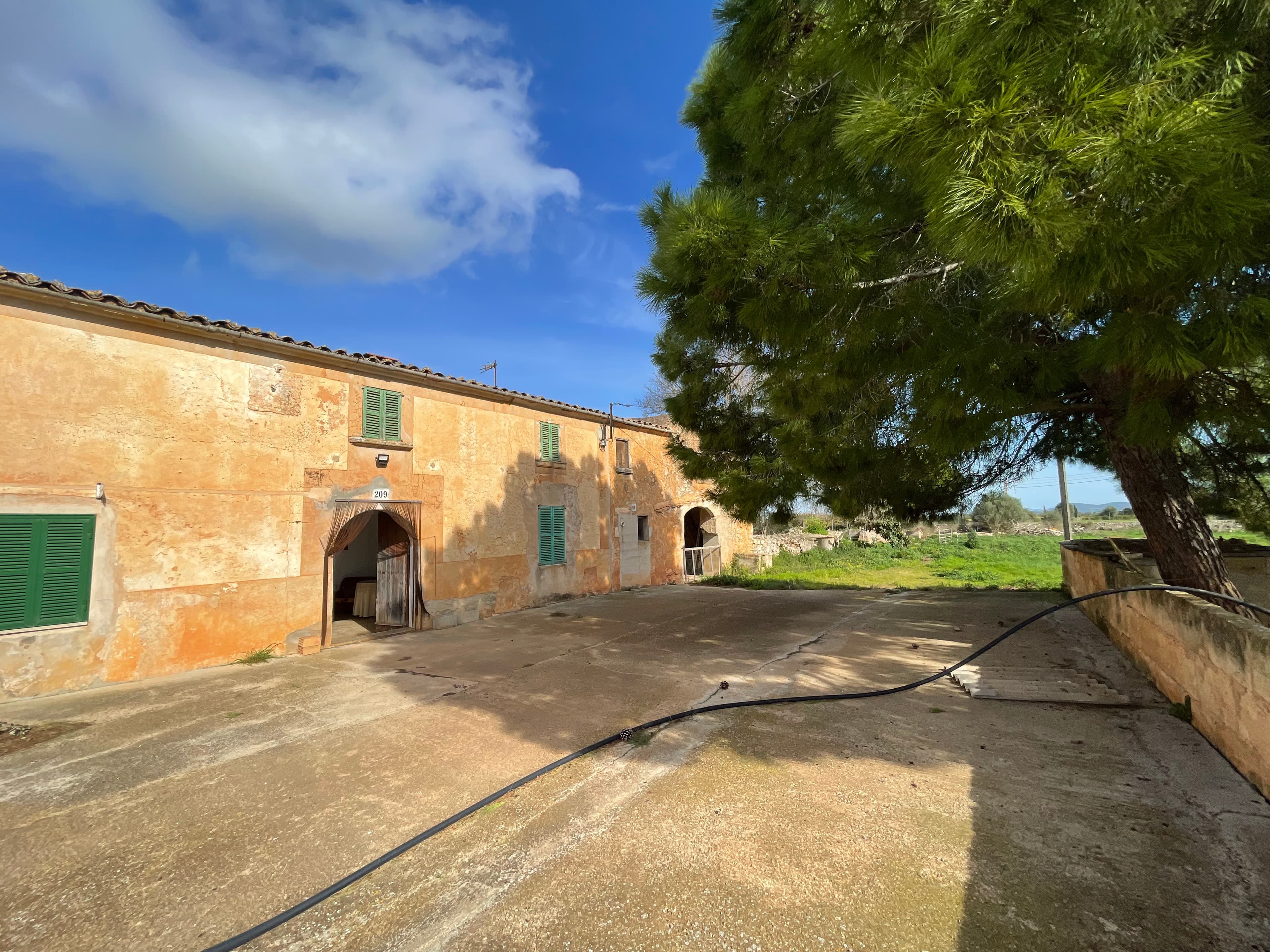 Traditional Mallorcan finca with great potential near FelanitxThis authentic Mallorcan finca is located in peaceful and scenic surroundings just a few minutes’ drive from the town of Felanitx, enjoying beautiful views of the surrounding countryside and Sant Salvador.The property sits on a plot of approximately 16,000 m² and comprises several traditional stone buildings with a total built area of around 720 m².The buildings are distributed across several structures, including a main house, additional residential or guest buildings, as well as former agricultural buildings and storage areas. The approximate distribution of the built area is as follows:Main house: approx. 200 m²Additional residential/guest building: approx. 120–150 m²Agricultural buildings, stables and outbuildings: approx. 350–400 m²The buildings are arranged around a traditional courtyard and offer plenty of authentic Mallorcan character and charm.The plot provides a high level of privacy and offers excellent opportunities to create beautiful outdoor living areas where one can fully enjoy the Mediterranean climate and the tranquil surroundings.A private access road to the property will be established in connection with the sale.The property has access to electricity and water supply via its own well and cistern.This is an exciting opportunity for buyers who wish to create their own finca full of character in a quiet area in the southeastern part of Mallorca.Note: Buyers are advised to verify the urban planning status of the property and the registration of the buildings with the relevant authorities.