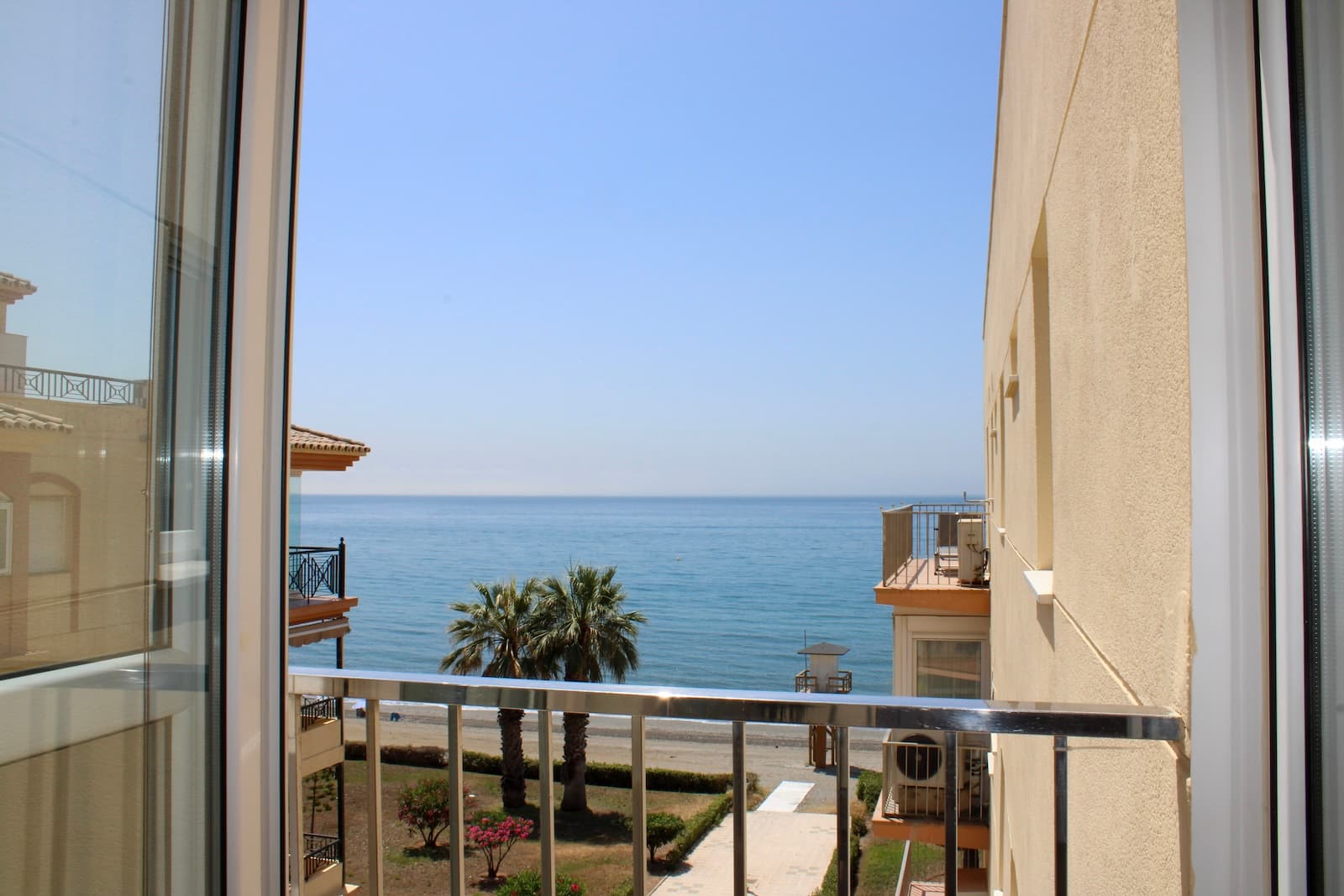 Well-maintained apartment with sea views on the first line in Penoncillo on Torrox Costa, located on the top floor with a lift in the house. A supermarket is located at the entrance to the house, restaurants around the corner and the beach one minute from your new home.The apartment has an excellent layout with two bedrooms and two complete bathrooms, one of the bedrooms is en-suite. Plenty of storage space, both bedrooms have built-in wardrobes.A fully equipped kitchen with a new washing machine, as well as a water heater. Central air conditioning is available in the apartment, which has been recently renovated. Double glazing throughout the apartment, which provides a pleasant indoor climate and a peaceful calm in the apartment.A spacious bright living room with a large lovely glazed terrace, with nice views of the mountains and the sea. The apartment has been recently repainted and the apartment is sold fully furnished, just move in. Parking space can be purchased for 20,000 euros.Malaga airport takes 45 minutes by car, but there is also a regular bus service from Torrox Costa. The renowned Baviera golf course is only 15 minutes by car from your new home. In winter, you only have an hour and a half drive to Granada, with skiing in the Sierra Nevada. Skiing in the morning and swimming in the afternoon, the best of both worlds.