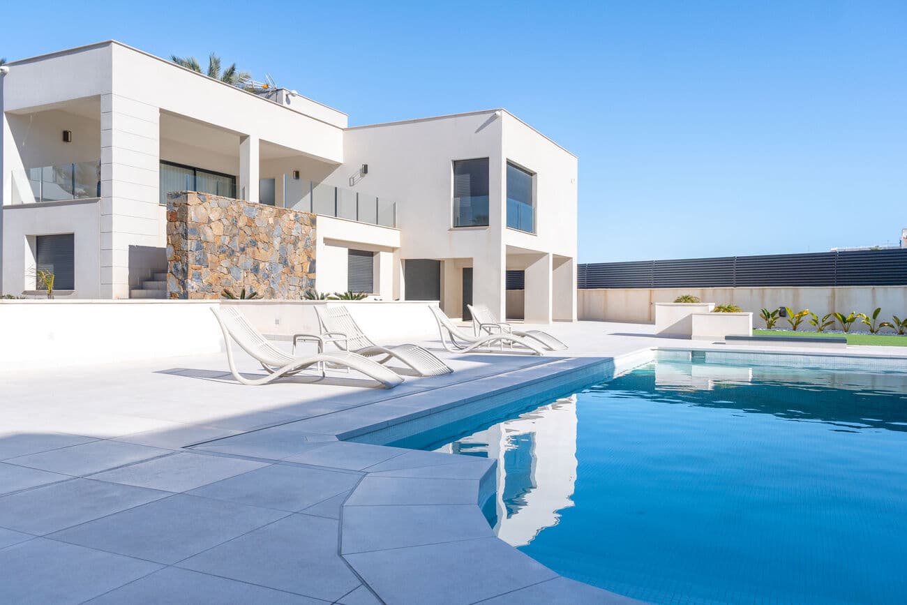 This exclusive, detached villa is situated in a sought-after location in La Veleta, Torrevieja – just steps from the sea – and boasts breathtaking, unobstructed sea views. The property combines modern architecture, high-quality materials, and a well-designed floor plan with the Mediterranean lifestyle of the Costa Blanca.Set on a generous plot of approximately 776 m², the property offers a built area of 369 m² and a living and usable area of 279 m². The two-storey house impresses with light-filled spaces, open-plan layouts, and spacious outdoor areas that can be enjoyed all year round.The heart of the villa is the bright living and dining area with direct access to the garden and private pool. The open-plan kitchen integrates seamlessly into the modern living concept. In total, there are five spacious bedrooms and three stylish bathrooms available – ideal for families or as a prestigious holiday home.On a generous 776 m² plot, the property offers a built area of ​​369 m² and 279 m² of living and usable space. The two-story house impresses with light-filled rooms, open-plan layouts, and spacious outdoor areas that can be enjoyed year-round.<br />The heart of the villa is the bright living and dining room with direct access to the garden and private pool. The open-plan kitchen blends harmonisch in das moderne Wohnkonzept integriert. Insgesamt fünf geräumige Schlafzimmer und drei Badezimmer.<br /><br />stylish bathrooms are available – ideal for families or as a prestigious holiday home.<br />A total of 5 spacious bedrooms and 3 stylish bathrooms are available – ideal for families or as a prestigious holiday home.<br /><br />Exclusive property details<br /><br />: Plot size: approx. 776 m²<br />Built area: approx. 369 m²<br />Living and usable area: approx. 279 m²<br />Bedrooms: 5<br />Bathrooms: 3<br /><br />Ground floor:<br />• 2 bedrooms<br />• 1 bathroom<br />• Separate living area<br />• Double garage<br /><br />First floor:<br />• Spacious living-dining room<br />• Open-plan kitchen<br />• 3 bedrooms<br />• Master bedroom with en-suite bathroom •<br />Additional bathroom<br />• Sun terrace with unobstructed views<br /><br />Exterior:<br />The well-maintained garden with high-quality artificial turf offers a variety of uses, including a mini-football area and several lounge and relaxation zones.<br />The private swimming pool with approx. 50 m² of water surface is surrounded by a sunny terrace and creates an ideal atmosphere for relaxation and socializing outdoors.<br />The fully fenced property guarantees maximum privacy and security.<br /><br />Features & Highlights:<br />– South-facing orientation<br />– High-quality materials and excellent workmanship<br />– Air conditioning and climate control system<br />– Private garage (approx. 40 m²)<br />– Storage/basement room<br />– Modern security system with 24/7 monitoring, live video, and connection to local authorities<br />– Control and monitoring worldwide via smartphone or computer<br />– Previously owned, very well-maintained condition<br />– Energy certificate available – very good energy efficiency (Class B)<br /><br />Location:<br />This exclusive villa enjoys a privileged Mediterranean-front location in La Veleta. The sea stretches directly in front of the property, giving it an exceptional location. At the same time, the beaches of the Orihuela Costa and the center of Torrevieja are just minutes away. International schools, world-class golf courses, shopping centers, and a diverse range of restaurants complete the excellent infrastructure.<br /><br />Here, sea, sun, and Mediterranean lifestyle combine with privacy and upscale living comfort. 