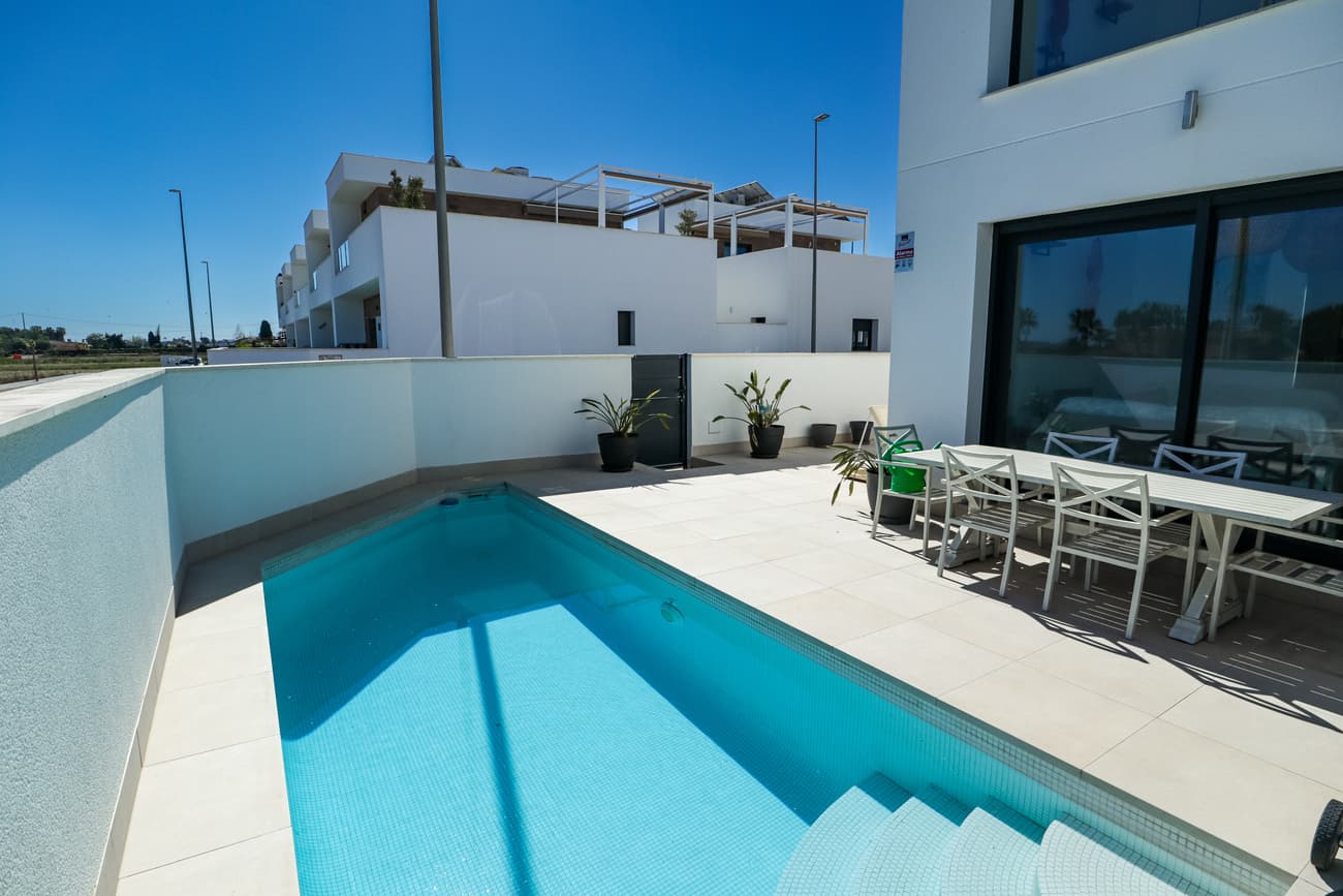 Detached villa in Daya Vieja, Alicante, Costa Blanca<br />Set in the peaceful village of Daya Vieja, this exceptional detached villa offers a rare combination of modern comfort, privacy, and uninterrupted countryside views. Built in 2019 and maintained in excellent condition, the property sits on a 188 m² plot directly opposite protected farmland—guaranteeing open, natural scenery that will never be built on.<br /><br />With 138 m² of thoughtfully designed living space, the villa welcomes you with a bright and spacious living room that flows seamlessly into a contemporary open-plan kitchen. The ground floor also features a double bedroom, a stylish bathroom, and a practical laundry room—ideal for convenient everyday living or hosting guests.<br /><br />Upstairs, you’ll find two generous double bedrooms, each with its own en-suite bathroom, offering comfort and privacy for family and visitors alike. Every bedroom is equipped with built-in wardrobes, ceiling fans, and air conditioning, ensuring year-round comfort throughout the home.<br /><br />One of the standout features is the stunning rooftop solarium, where panoramic views of the surrounding fields create a truly relaxing setting. Fully equipped with water and electricity, this space includes a summer kitchen with sink and fridge, as well as an elegant pergola—perfect for outdoor dining, entertaining, or simply enjoying the Mediterranean lifestyle.<br /><br />Outside, the villa boasts a beautiful private swimming pool, a storage room, and secure on-plot parking with an electric gate. The property’s east-south orientation ensures excellent natural light throughout the day.<br /><br />The location offers the best of both worlds: a tranquil village setting with everyday amenities just a short walk away, including a pharmacy, bakery, health centre, restaurants, and a charming wine bar. A nearby sports centre provides a municipal pool, football pitch, padel courts, and a children’s playground.<br /><br />Ideally situated, the villa is only:<br /><br />10 minutes from the beaches<br />5 minutes from shops and restaurants<br />35 minutes from Alicante Airport<br /><br />Offered at €379,000, this is a fantastic opportunity to own a stylish, move-in-ready home in a sought-after area of the Costa Blanca—perfect as a permanent residence, holiday home, or investment.