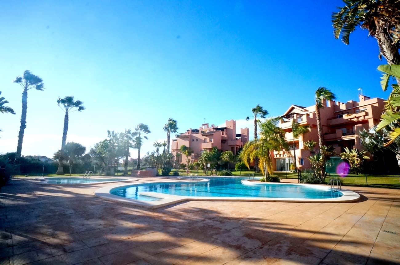 Spacious 2-bedroom, 2-bathroom apartment in the heart of the Mar Menor Golf Resort, overlooking the communal pool and the 16th hole of the golf course. This charming first-floor apartment features two large bedrooms and two full bathrooms. The master bedroom has an en-suite bathroom and access to the main terrace. The second bedroom has its own terrace and shares the second bathroom. Fitted wardrobes in both bedrooms offer excellent storage space. The kitchen is fully furnished and equipped with appliances, including a ceramic hob, oven, dishwasher, washing machine, fridge/freezer, and extractor hood. The bright and inviting living-dining room offers direct access to a terrace where you can relax and enjoy the Mediterranean climate. The property is sold furnished and is in immaculate condition. Parking is included in the price, which also includes a private parking space in the underground garage. This apartment is a unique opportunity you won't want to miss. Come and see it and fall in love with your new home!The mar menor golf resort is one of the leading golf resort in the area. With is amenities all on walking distance and its 24u security, its easy and very safe and secure to enjoy the mediterean climate. Only 6km from the calm waters of the Mar Menor, you also can enjoy the beach and sea.