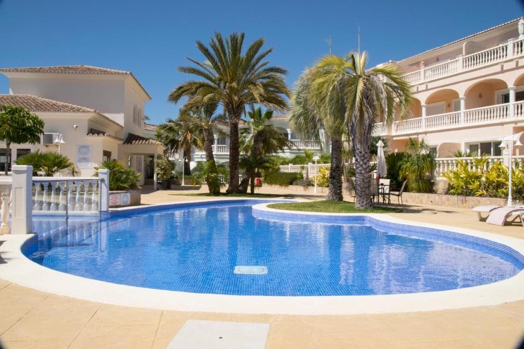 This elegant two-bedroom apartment is located in a renowned and exclusive resort on the beloved Costa Blanca. The project was executed following extremely high-quality standards, combining modern technology with a refined and luxurious finish.This is a tourist apartment with a lifetime tourist license. You can enjoy it whenever you want and, when not in use, entrust it to the resort for passive income.The resort is designed to provide an exceptional residential experience in a tranquil and green setting. La Fustera beach is within walking distance, while Calpe and Moraira are easily accessible in just a few minutes. The complex enjoys an excellent reputation due to its thoughtfully designed architecture, high-quality construction, and focus on comfort and innovation.This project has been awarded the prestigious Golden Overseas Award for the best apartment complex in Spain.The common facilities are also top-notch: an impressive lagoon-style pool with a separate children's pool, surrounded by a beautifully maintained Mediterranean garden, and a spacious wellness area featuring a heated indoor pool, jacuzzi, sauna, and gym. The property is completely enclosed and secure, ensuring privacy and peace.The apartment itself radiates warmth and comfort and is perfect as a vacation home, permanent residence, or profitable investment. Additionally, there are guaranteed rental income, making this property even more appealing from a financial perspective. The apartment has a rental license that covers the entire project, so it never expires.The layout includes a spacious living and dining area with a semi-open kitchen, two complete double bedrooms, a bathroom, and a large partially covered terrace with sea views. Furthermore, the apartment is equipped with air conditioning (cold/heat), internet and satellite television, an elevator in the building, its own washer and dryer, and a private parking space in the underground garage.Since its delivery, this project has been unanimously praised by both professionals and residents for its level of finish and craftsmanship.Come see it in person; it’s the best way to experience the quality and ambiance.