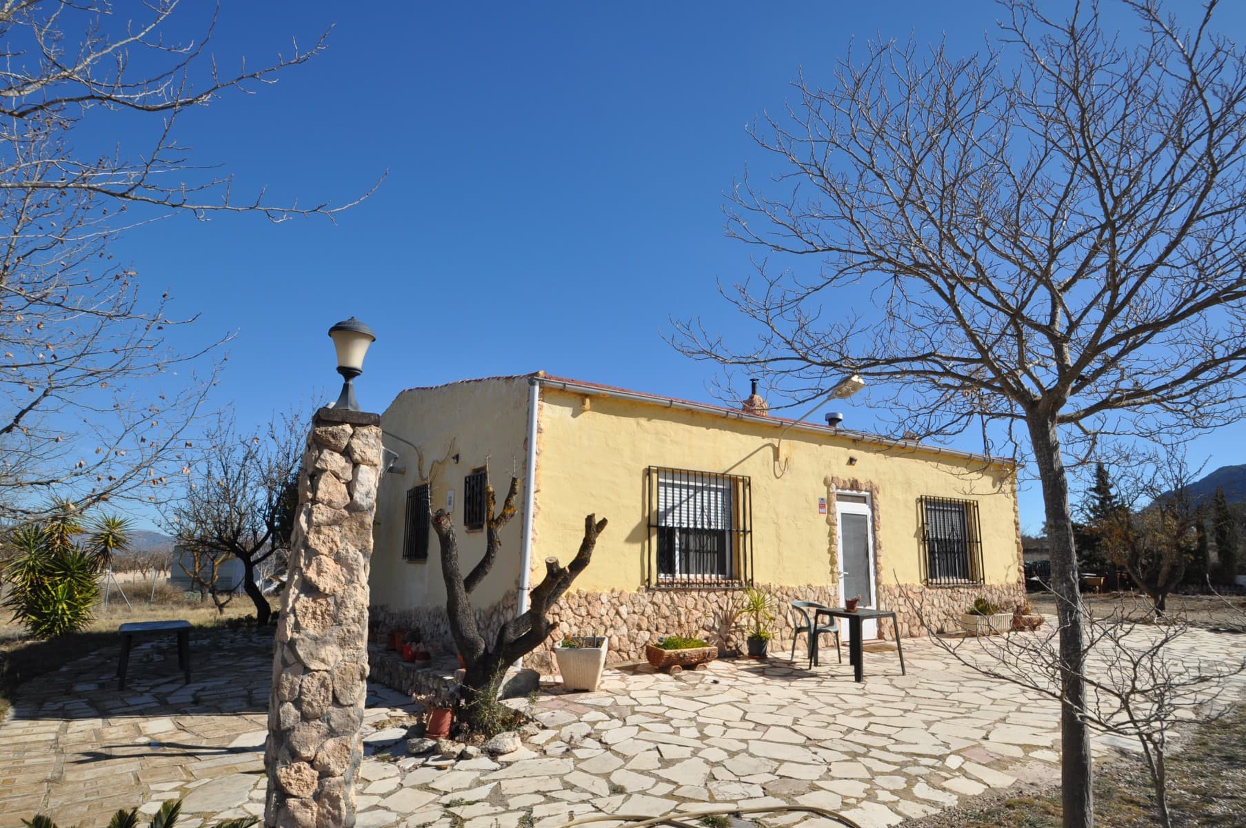 Located just minutes from the lovely town of Salinas, and 5 mins from Sax, Alicante, this property offers a peaceful rural lifestyle with modern convenience. Set on a fenced plot with almond trees, this home provides space, privacy, and easy access via a fully paved road right to the entrance.The main house is 100m² and well-distributed, while a separate 55m² guest unit—partially mobile and partially built—adds extra living space. The property includes a small vegetable garden with lettuce, tomatoes, and other fresh produce, as well as a fenced area for chickens, making it ideal for those looking to embrace a more self-sufficient lifestyle.Enjoy the benefits of country living without being isolated. This home offers independence while still being close to local amenities. A great opportunity for those seeking a quiet retreat in the Alicante countryside.If you liked this property, do not hesitate to contact us to organize a visit, we will be happy to help you!