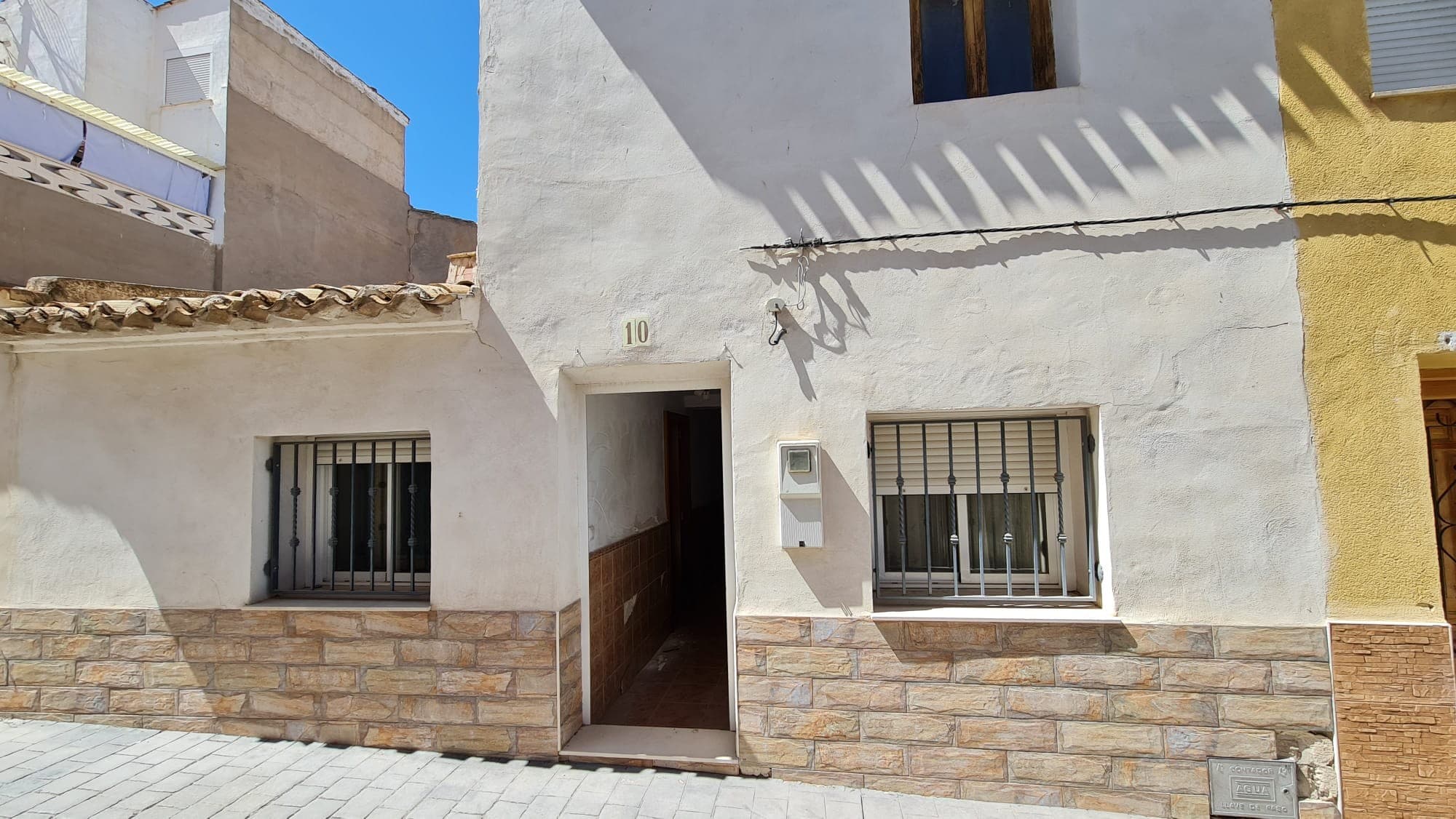 This 4-bedroom, 1-bathroom townhouse in Salinas, Alicante, offers spacious living with the potential for customization. The property features a small laundry patio and comes furnished, including white goods. Air conditioning ensures comfort throughout the year.Although mains electricity and water are currently disconnected, they are available. The upstairs area is empty, providing an excellent opportunity to create a master suite. The townhouse includes a large garage and, despite some water damage, is in good overall condition. If the full asking price is paid the sellers will reconnect the water and electricity at their expense. Please be aware that the property is being offered at a reduced price because of some water damage to the walls due to a blocked drain, which has since been resolved. In terms of work you will need to replace a few doors, fix some plastering, and replace a few tiles that have come off the walls. The upstairs needs to be fully reformed. Conveniently located within walking distance to all amenities, this townhouse is perfect for those looking to personalize their new home while enjoying the benefits of a central location.We have a large portfolio of properties in the Costa Blanca and Costa Calida areas, specialising in country properties, villas, fincas, building plots and design and build options in the Alicante and Murcia regions with a particular emphasis on Elda, Monovar, Pinoso, Sax, Villena, Aspe, Fortuna, Albacete and many more surrounding areas. We have been established since 2004 and have decades of experience between the team which we bring to bear to help you find and secure your new dream home. We help you every step of the way to make sure your purchase in Spain is safe and hassle free. We are not here to sell you a property, we are here to help you realise your dream and find what is right for you. With us you are in the safest hands. Contact us now to have a no obligation chat about how you too can realise your dreams.