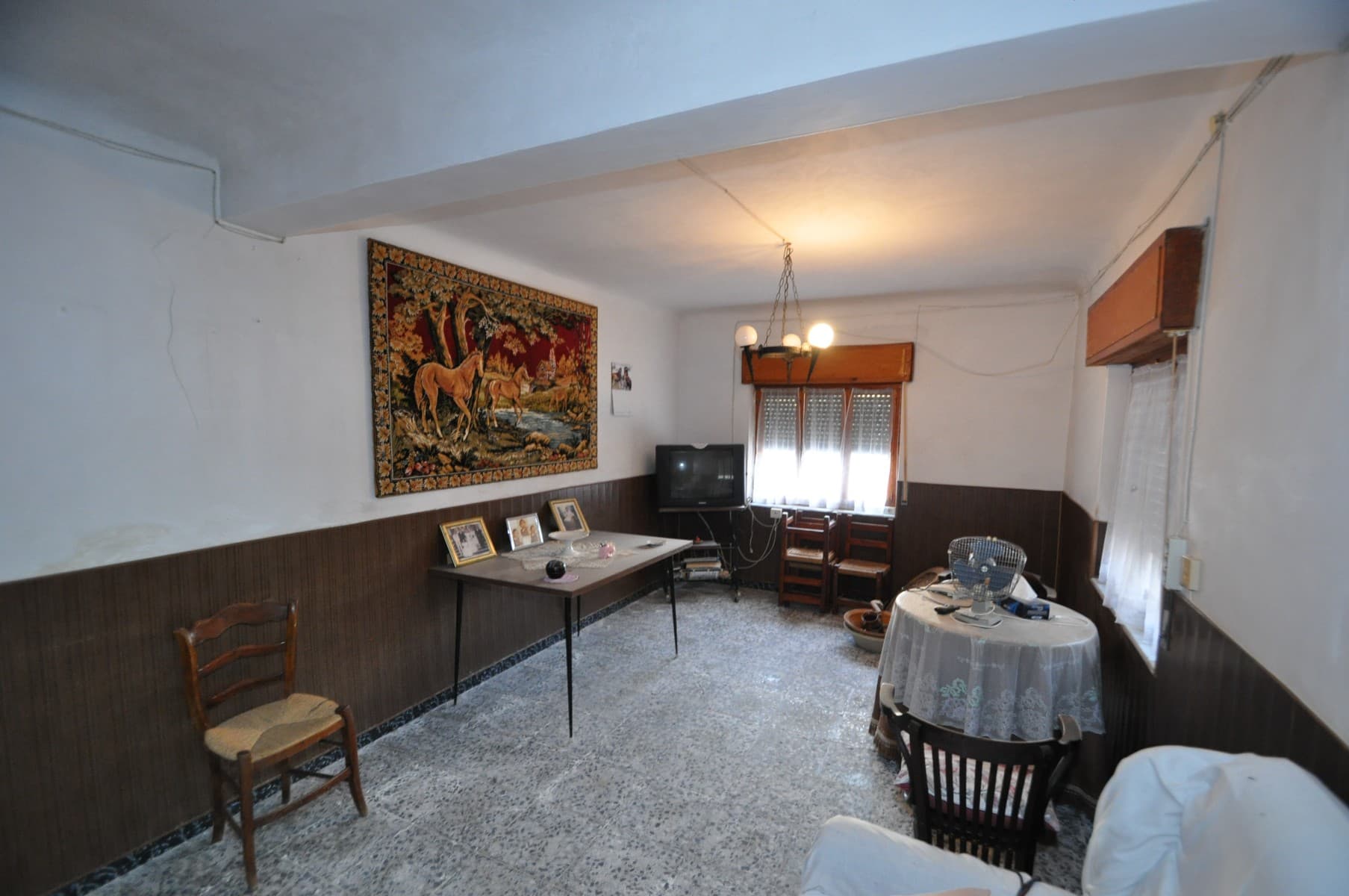 Traditional Village House with Garden Plot Near PinosoLocated in a small and peaceful hamlet near Pinoso, this traditional two-storey house offers generous living space, character, and plenty of potential for its next owner. Surrounded by countryside and enjoying a quiet setting, it is ideal for anyone looking for an authentic Spanish home with room to personalise and develop.The property features six bedrooms distributed across both floors, providing ample accommodation for a large family, guests, or even a home office. Upstairs, two of the bedrooms benefit from their own private terraces, perfect for enjoying the views and the peaceful surroundings. The house also offers plenty of storage space throughout.A 200 m² plot is included in the sale, located just across a small country lane from the house. The lane is quiet and lightly used, making access easy. The plot provides an excellent opportunity to create a garden, vegetable patch, outdoor entertaining area, or additional leisure space to complement the home.The property is connected to mains water and electricity, allowing the new owners to move in and make improvements at their own pace.About the AreaThis property is situated just a short drive from Pinoso, one of the most popular inland towns in Alicante. Pinoso offers a wide range of amenities including supermarkets, restaurants, schools, sports facilities, and medical services. Known for its vineyards, local cuisine, and friendly community, the town combines traditional Spanish charm with everyday convenience. The surrounding countryside is perfect for walking, cycling, and enjoying a relaxed lifestyle, while Alicante airport and the Costa Blanca beaches are within easy reach.