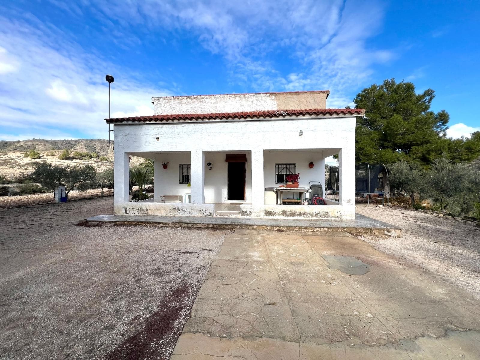 This welcoming country house offers a peaceful natural setting, ideal for those seeking privacy and a relaxed lifestyle while remaining close to local amenities. The property is laid out on a single level, providing a comfortable and practical living space.The house features three bedrooms, one bathroom, an independent kitchen, and a spacious living room with a fireplace, creating a warm and inviting atmosphere. It also includes air conditioning and a garage. Outside, there is a barbecue area, perfect for family gatherings and outdoor enjoyment. The plot measures 3.216 m², offering ample space to enjoy the surrounding countryside.The property is connected to mains electricity and irrigation water, making it suitable for both permanent living and weekend retreats.Location and Surroundings Set in a very quiet area and surrounded by nature, the property is located just five minutes by car from the town of Monóvar. Monóvar offers a full range of services, including shops, schools, restaurants, and medical facilities. This location combines the tranquillity of the countryside with the convenience of having all essential services close by.We have a large portfolio of properties in the Costa Blanca and Costa Calida areas, specialising in country properties, villas, fincas, building plots and design and build options in the Alicante and Murcia regions with a particular emphasis on Elda, Monovar, Pinoso, Sax, Villena, Aspe, Fortuna, Albacete and many more surrounding areas. We have been established since 2004 and have decades of experience between the team which we bring to bear to help you find and secure your new dream home. We help you every step of the way to make sure your purchase in Spain is safe and hassle free. We are not here to sell you a property, we are here to help you realise your dream and find what is right for you. With us you are in the safest hands. Contact us now to have a no obligation chat about how you too can realise your dreams.