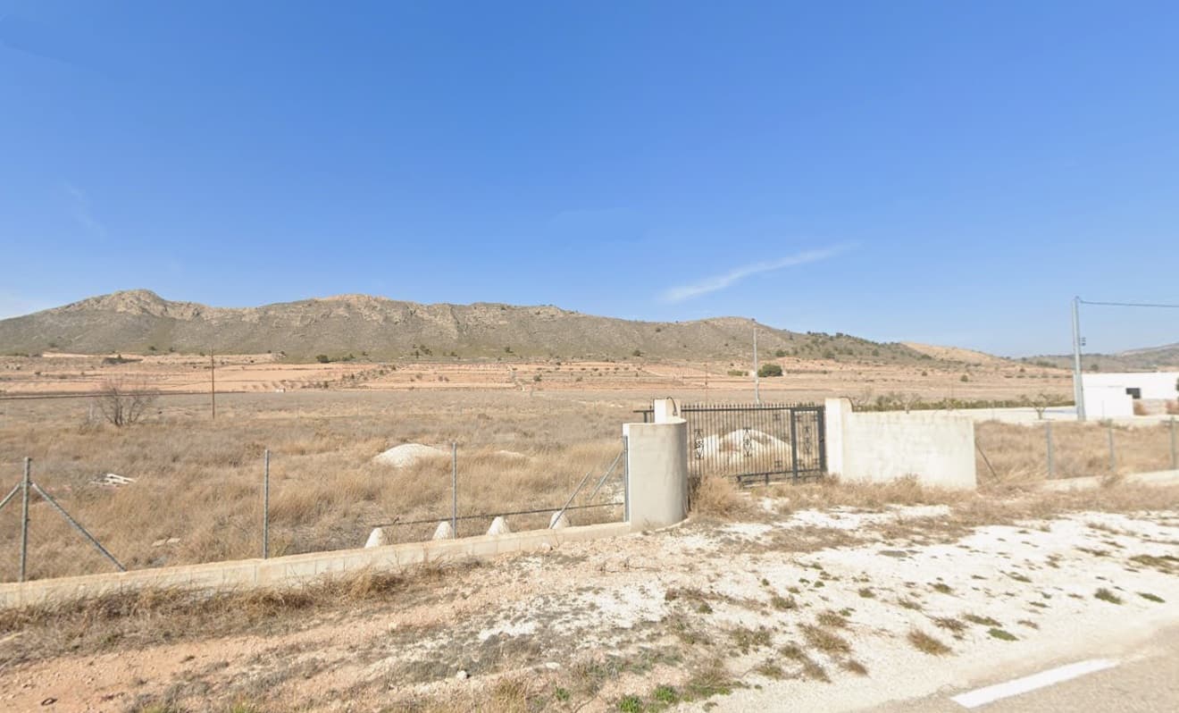Building parcel of 5001 m2 in a walking distance from village of Cañada de la Leña. You can build up to 250 m2 on a single level (or 200 m2 over 2 levels), the property comes with a building confirmation. The plot is all fenced with a chain link fence upon a brick wall, and a metal gate, all with a value of 25.000€. Electric is connected, drinking water is at the border of the property. The access is via comfortable tarmac road, there are new built villas in the neighbourhood. The land is located in a valley, surrounded by vineyards, rolling hills, in expat-friendly area.Distances:Cañada de la Leña (the closest village with a bar) - 1 kmAlgueña (the closest larger village with a supermarket) - 7 minPinoso (the closest town with markets, schools, clinics, vet, gyms, etc.) - 14 minElche (the closest city) - 40 minAlicante airport - 50 minBeach - 52 minAbout the area: Pinoso (Alicante, Spain), known for its stunning countryside, and welcoming atmosphere, offers a perfect blend of traditional Spanish culture and modern conveniences. Surrounded by picturesque vineyards and rolling hills, Pinoso is renowned for its quality of life, with excellent local amenities, schools, and easy access to both the vibrant cities of Alicante and Elche, as well as beautiful Mediterranean beaches. Whether you're seeking a peaceful rural retreat or a family-friendly community, Pinoso is an ideal place to invest in property, combining serene living with great potential for growth.About us: We have a large portfolio of properties in the Costa Blanca and Costa Calida areas, specialising in country properties, villas, fincas, building plots and design and build options in the Alicante and Murcia regions with a particular emphasis on Elda, Monovar, Pinoso, Sax, Villena, Aspe, Fortuna, Albacete and many more surrounding areas. We have been established since 2004 and have decades of experience between the team which we bring to bear to help you find and secure your new dream home. We help you every step of the way to make sure your purchase in Spain is safe and hassle free. We are not here to sell you a property, we are here to help you realise your dream and find what is right for you. With us you are in the safest hands. Contact us now to have a no obligation chat about how you too can realise your dreams.