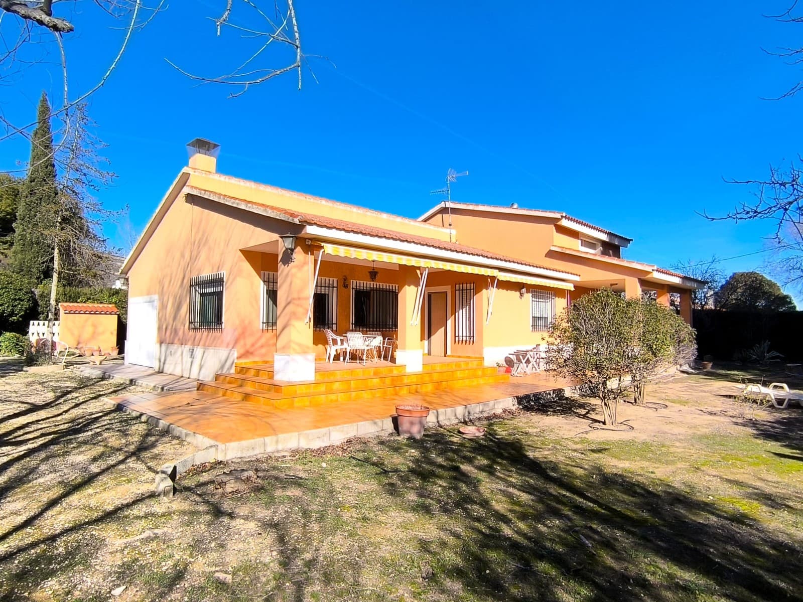 Well-maintained and ready to move in, this spacious villa offers 230 m² of built area and a total of six bedrooms. The property is composed of two connected parts, providing great flexibility for use as one large family home or as two independent living units.The first part, all on the ground floor, features a generous living room with a fireplace and dining area, three bedrooms, a bathroom, and a fully equipped kitchen. The second part includes a living room with an open kitchen and fireplace, two bedrooms (one with an en suite bathroom), and an upper floor with an additional living room and a sixth bedroom.Each section has its own independent access, making the property ideal for extended family living, rental potential, or guest accommodation, while still allowing it to function as a single unified villa if desired. The house also includes a garage and a small covered porch.The villa is equipped with central gas heating, ceramic flooring, quality finishes, working appliances, and tasteful furniture, making it truly ready to move into and offered at a very attractive price. Connections to mains water, electricity, and sewage are a matter of course.Set on a plot of over 2,300 m², the outdoor space offers covered parking for two cars, ample additional parking, and a beautiful garden with mature trees that provide shade and a peaceful atmosphere. There is also the possibility to build a swimming pool.Located in a quiet Spanish neighbourhood, the property enjoys privacy and easy access, while being within walking distance of the town of Caudete, where all services and amenities are available.About the area: Caudete is a charming and peaceful town of 10.000 inhabitants in the province of Albacete, known for its traditional Spanish character and welcoming community. Ideally located, it offers excellent road connections and is just 50 minutes from the beaches of the Costa Blanca and Alicante International Airport. The proximity of mountains offers ample hiking opportunities and splendid views. The town, which has all the daily amenities (shops, health centre, farmer's market, local services) provides easy access to major cities such as Alicante, Murcia, and Valencia, making it a perfect location for those seeking a tranquil lifestyle with the convenience of nearby urban centers and coastal escapes.About us: We have a large portfolio of properties in the Costa Blanca and Costa Calida areas, specialising in country properties, villas, fincas, building plots and design and build options in the Alicante and Murcia regions with a particular emphasis on Yecla, Novelda, Elda, Monovar, Pinoso, Sax, Villena, Aspe, Fortuna, Jumilla, Abanilla, and many more surrounding areas. We have been established since 2004 and have decades of experience between the team which we bring to bear to help you find and secure your new dream home. We help you every step of the way to make sure your purchase in Spain is safe and hassle free. We are not here to sell you a property, we are here to help you realise your dream and find what is right for you. With us you are in the safest hands. Contact us now to have a no obligation chat about how you too can realise your dreams.