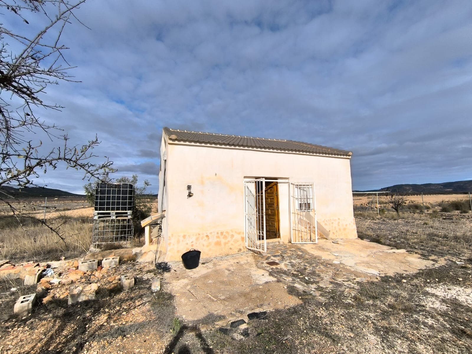 Are you looking for an viable investment? Agricultural adventure? Or just a huge, private property, where you could do anything you'd like to? All of that for less than 100k? You've come to the right place! The property features:a little reformed detached country house of 54 m2, with a little bathroom, and the rest being a large single room, with an open kitchen and plenty of space for further development (salon, bedroom, storage). Thanks to its high ceiling, another floor could be added easily.a covered car port with an enclosed shed of 2 roomsfenced garden of 4500 m2.The house with the fenced plot can be bought separately for 49.000€ - see ref. 41055a on our website: 41055a-PB - Country house in YeclaFurthermore, there are 50.000 m2 of century old olive orchards, 20.000 m2 of almonds and 50.000 m2 of field for cereal cultivation. All land and trees are cared of and in full production. The property is located in calm, rural area, 10 km from Yecla.For 98.000 €, the property offers price of less than 1€ per m2, and a little house on top of that. Don't hesitate and contact us to arrange a viewing!PLEASE NOTE: that on the title Deeds there is only a plot of 4,447 m2 there is no building registered on the plot at the land registry. There was a chance that this can be fixed at the point of sale with a couple of certificates from an architect, but there is no guarantee. The property is being sold as is and the seller is not willing to carry out the required work. Please be clear before arranging viewing with us.From the research that we have done the property has existed since the 1950s but over time it was left to go to ruin. The current owner bought the property in 2006 and by 2016 had carried out all the repair work to bring it to its current state. No action has been taken by the town hall since then and as such the minimum period of 4 years has transpired so the property is deemed to be prescribed. Having said that, because it is so close to the boundary on the north side, there is no guarantee that the land registry will allow it to be registered. This is why the current owner is selling it as seen. If you have any questions or queries about the above please don't hesitate to contact us to ask for more detailed information.About the area: Yecla is a charming and historic town of app. 35000 inhabitants, located in the region of Murcia. It is renowned for its award-winning wines, historical landmarks, and vibrant local culture. The surrounding natural landscapes of scenic mountains, vineyards and almond groves provide opportunities for outdoor activities, while the town itself offers all necessary services, including hospital, schools, shops, restaurants, and other services. With a friendly local community, lively markets, excellent gastronomy, and easy access to nature, Yecla is an ideal location for those seeking authentic Spanish lifestyle - just about an hour from the coast and Alicante airport.About us: We have a large portfolio of properties in the Costa Blanca and Costa Calida areas, specialising in country properties, villas, fincas, building plots and design and build options in the Alicante and Murcia regions with a particular emphasis on Yecla, Novelda, Elda, Monovar, Pinoso, Sax, Villena, Aspe, Fortuna, Jumilla, Abanilla, and many more surrounding areas. We have been established since 2004 and have decades of experience between the team which we bring to bear to help you find and secure your new dream home. We help you every step of the way to make sure your purchase in Spain is safe and hassle free. We are not here to sell you a property, we are here to help you realise your dream and find what is right for you. With us you are in the safest hands. Contact us now to have a no obligation chat about how you too can realise your dreams.