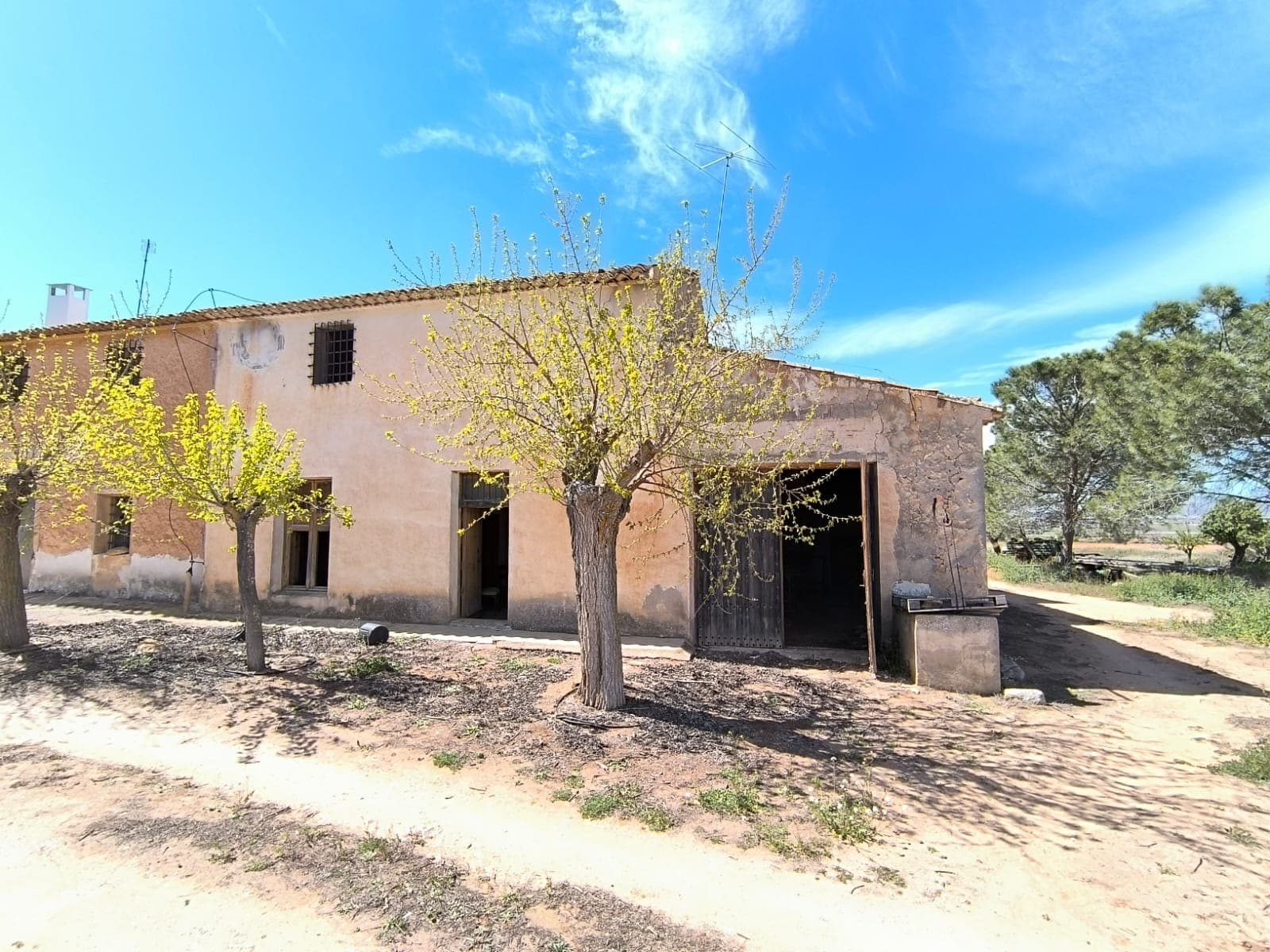 Large semi-detached country house, located in a quiet hamlet approximately 10 minutes from the town of Yecla, in need of total reform. This old rustic house, with thick solid walls made of stone, has characteristic rustic features, such as large fireplaces, pigeon housing, or a hidden patio. There is a large garage in the corner of the house. With 200 m2 on the first floor, and another set of rooms and a roof terrace above it, this property offers substantial size for a bargain. Please note that it is not ready to move in, and is in a need for a structural reform, including the roof, several walls, ceilings, plumbing, wiring, etc. With the necessary investments made, the house will turn into a lovely country home of your taste.With the house also comes a little olive grove. Adult trees in production, in need of pruning, will make a lovely garden, and a source of your own olive oil.Although not connected at the moment, both mains electric and irrigation water are available in the area. Furthermore, you'll get a little shaded outside space to enjoy, and access to a well with underground water source, shared with the neighbours. About the area: Yecla is a charming and historic town of app. 35000 inhabitants, located in the region of Murcia. It is renowned for its award-winning wines, historical landmarks, and vibrant local culture. The surrounding natural landscapes of scenic mountains, vineyards and almond groves provide opportunities for outdoor activities, while the town itself offers all necessary services, including hospital, schools, shops, restaurants, and other services. With a friendly local community, lively markets, excellent gastronomy, and easy access to nature, Yecla is an ideal location for those seeking authentic Spanish lifestyle - just about an hour from the coast and Alicante airport.About us: We have a large portfolio of properties in the Costa Blanca and Costa Calida areas, specialising in country properties, villas, fincas, building plots and design and build options in the Alicante and Murcia regions with a particular emphasis on Yecla, Novelda, Elda, Monovar, Pinoso, Sax, Villena, Aspe, Fortuna, Jumilla, Abanilla, and many more surrounding areas. We have been established since 2004 and have decades of experience between the team which we bring to bear to help you find and secure your new dream home. We help you every step of the way to make sure your purchase in Spain is safe and hassle free. We are not here to sell you a property, we are here to help you realise your dream and find what is right for you. With us you are in the safest hands. Contact us now to have a no obligation chat about how you too can realise your dreams.
