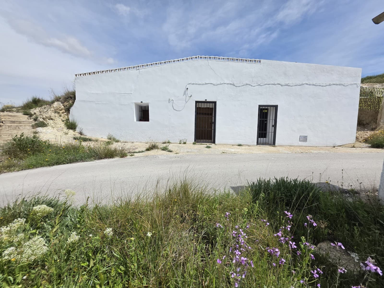 Cave House with Land and Open Views in La ZarzaThis traditional cave house is located in the peaceful area of La Zarza, offering a unique living space with easy access from the main road via a tarmac track. Set on a 4,341 m² plot, the land includes olive trees and open views across the surrounding countryside.The cave house provides a natural and comfortable environment, with good ventilation in all rooms thanks to windows, creating a light and pleasant interior. The layout includes two bedrooms, a living room, and a kitchen, all built into the cave, maintaining a stable temperature throughout the year.Outside, there is a separate building with a toilet and sink. The elevated position offers wide and attractive views, making it an ideal spot for those looking to enjoy a quiet and natural setting.About the Area La Zarza is a rural area located between Pinoso and Jumilla, known for its peaceful surroundings, vineyards, and open landscapes. It is ideal for those seeking a quiet lifestyle away from busy towns, while still being within driving distance of local amenities. Nearby Pinoso and Jumilla offer shops, restaurants, and essential services, along with a strong local culture and wine-producing tradition. The area is well connected by road, allowing access to larger towns, Alicante airport, and the coast.We have a large portfolio of properties in the Costa Blanca and Costa Calida areas, specialising in country properties, villas, fincas, building plots and design and build options in the Alicante and Murcia regions with a particular emphasis on Elda, Monovar, Pinoso, Sax, Villena, Aspe, Fortuna, Albacete and many more surrounding areas. We have been established since 2004 and have decades of experience between the team which we bring to bear to help you find and secure your new dream home. We help you every step of the way to make sure your purchase in Spain is safe and hassle free. We are not here to sell you a property, we are here to help you realise your dream and find what is right for you. With us you are in the safest hands. Contact us now to have a no obligation chat about how you too can realise your dreams.