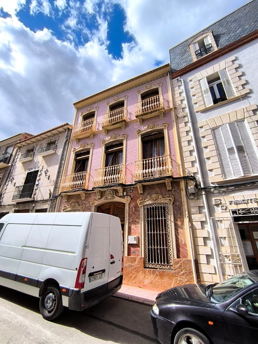 Step into a piece of history with this remarkable townhouse, built in 1915, located in the very centre of Caudete. Rich in character and authenticity, the property has been carefully maintained and tastefully restored, preserving many of its original features—beautiful tiled floors, grand staircases, solid wood doors, traditional windows, and even period furnishings.The home is distributed across three spacious floors. Upon entering through an impressive solid wooden door, you're welcomed by entrance hall and its beautifully painted high ceilings and timeless decorative details. The ground floor offers a noble, elegant living room with fireplace, alongside several versatile rooms - as offices, meeting areas, and a dining room, plus a kitchen and bathroom.A striking marble staircase leads to the first floor, where a generous living room and several large bedrooms await—many with original flooring, high ceilings, and balconies that bring in natural light and views of the surrounding streets.The top floor reveals a large high attic space, largely open and full of potential, ideal for further development, studio use, or additional rooms.To the rear, the property features a private patio and a two-level storage area, adding practicality.The house is in good structural condition, with functioning plumbing and electrical systems, and is connected to mains water, electricity, and sewer. It has been protected against damp over the years. While the roof may require attention in the future, preventative measures have already been taken to prevent water leakage.This modernist-style residence is not a conventional home - it's a property with soul. Suitable only for those, who appreciate history, unique architectural character, and the charm of a bygone era, as well as for buyers seeking a distinctive opportunity for boutique accommodation or a special private residence.Ask as for a viewing or for our commented walkthrough video!*Please note that some of the furniture and paintings are NOT included in the price and have to be negotiated independently.About the area: Caudete is a charming and peaceful town of 10.000 inhabitants in the province of Albacete, known for its traditional Spanish character and welcoming community. Ideally located, it offers excellent road connections and is just 50 minutes from the beaches of the Costa Blanca and Alicante International Airport. The proximity of mountains offers ample hiking opportunities and splendid views. The town, which has all the daily amenities (shops, health centre, farmer's market, local services) provides easy access to major cities such as Alicante, Murcia, and Valencia, making it a perfect location for those seeking a tranquil lifestyle with the convenience of nearby urban centers and coastal escapes.About us: We have a large portfolio of properties in the Costa Blanca and Costa Calida areas, specialising in country properties, villas, fincas, building plots and design and build options in the Alicante and Murcia regions with a particular emphasis on Elda, Monovar, Pinoso, Sax, Villena, Aspe, Fortuna, Albacete and many more surrounding areas. We have been established since 2004 and have decades of experience between the team which we bring to bear to help you find and secure your new dream home. We help you every step of the way to make sure your purchase in Spain is safe and hassle free. We are not here to sell you a property, we are here to help you realise your dream and find what is right for you. With us you are in the safest hands. Contact us now to have a no obligation chat about how you too can realise your dreams.
