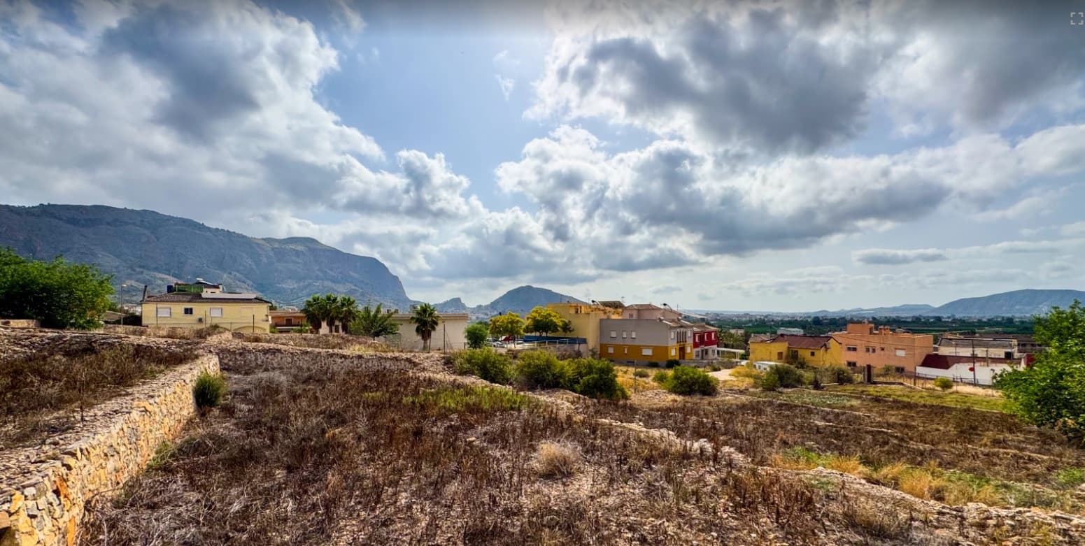 We present this excellent investment opportunity, particularly attractive for developers, thanks to the potential to build multiple residential units and resell them, as well as for alternative uses such as rural tourism, event venues, or leisure projects.Large 12,441 m2 estate located in Orihuela, just 2 km from the town center. Set at the foot of the Sierra de Orihuela, the property enjoys an elevated, non-floodable position with open views across the Vega del Segura and surrounding mountains.The land is distributed as follows:  3,488 m2 of residential urban land within the hamlet, suitable for development of up to two floors plus basement and mezzanine. Full plot occupation is permitted for semi-detached housing and 40% for detached homes. There is potential to develop around 30 semi-detached properties (approx. 6 m frontage by 18 m depth each). Alternative configurations possible as well.  1,133 m2 allocated for road infrastructure.  7,451 m2 of rustic land adjoining the urban area, with access to asphalted roads and main services including water, electricity, sewage, and telecommunications. This section is included in a proposed urban expansion plan under the new General Urban Plan of Orihuela.  369 m2 of urban residential land, with a beautiful, colonial-style house built on it:431 m2 over 2 floors, featuring 7 bedrooms, two living rooms, two gazebos, kitchen, bathroom, patio, storage room, and a small private chapel.  The property also benefits from its own well, two water deposits/pools, and irrigation rights of up to 10,000 m3 per year.About the area: Surrounded by established residential properties, the estate is located in a well-serviced area with supermarkets, schools, medical facilities, and public transport nearby. Orihuela is a historic town in the province of Alicante, known for its rich cultural heritage, traditional architecture, and scenic surroundings along the Segura River. It offers a mix of inland charm and coastal access, with both beaches and mountains just a short drive away. It is approximately 20 km from Murcia city, 30 km from the beaches of Orihuela Costa, Torrevieja, and Guardamar, and 35 km from Murcia airport and 60 km from Alicante International Airport. About us: We have a large portfolio of properties in the Costa Blanca and Costa Calida areas, specialising in country properties, villas, fincas, building plots and design and build options in the Alicante and Murcia regions with a particular emphasis on Yecla, Novelda, Elda, Monovar, Pinoso, Sax, Villena, Aspe, Fortuna, Jumilla, Abanilla, and many more surrounding areas. We have been established since 2004 and have decades of experience between the team which we bring to bear to help you find and secure your new dream home. We help you every step of the way to make sure your purchase in Spain is safe and hassle free. We are not here to sell you a property, we are here to help you realise your dream and find what is right for you. With us you are in the safest hands. Contact us now to have a no obligation chat about how you too can realise your dreams.