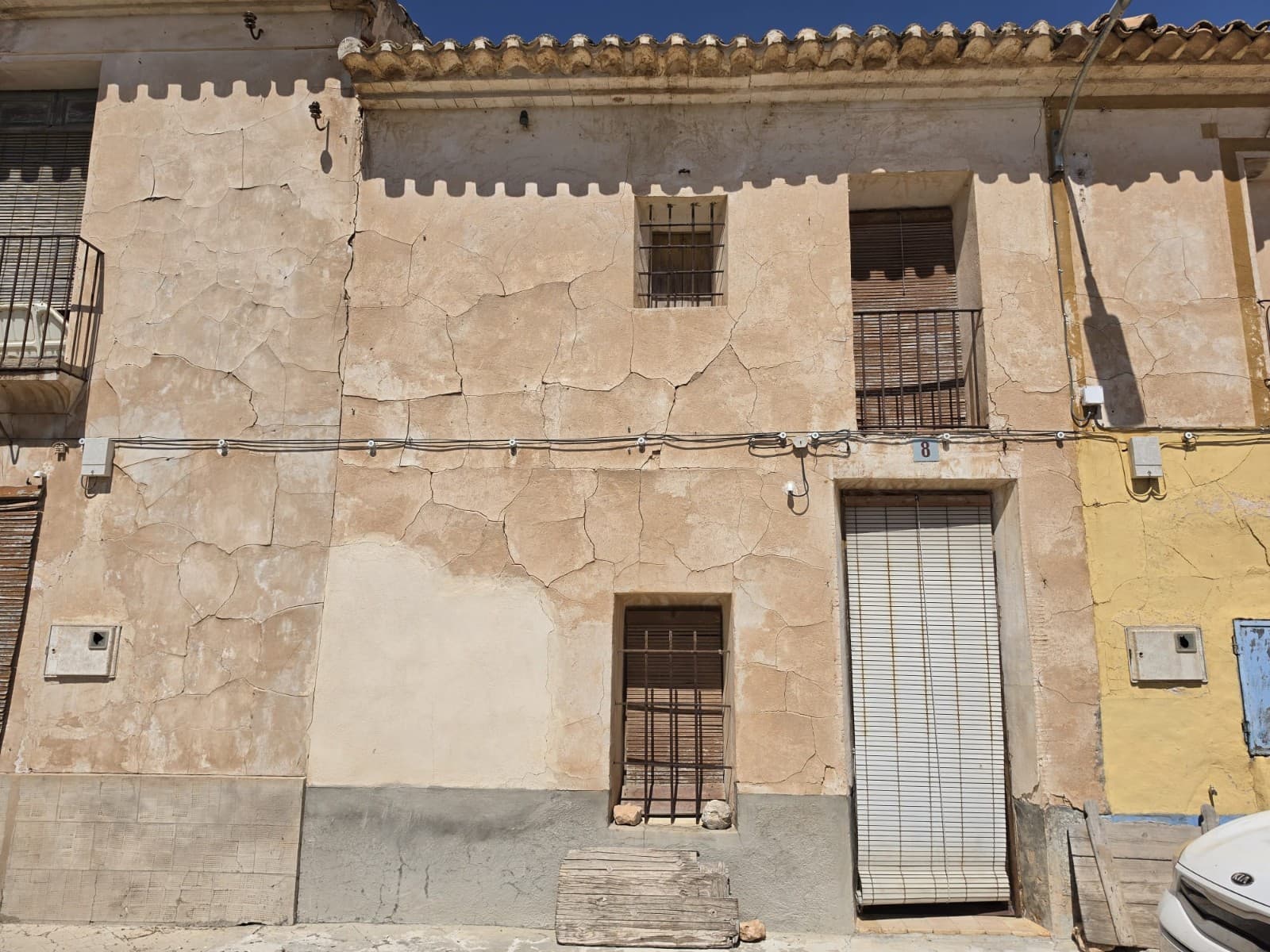 This large traditional townhouse is located in the peaceful village of La Canalosa, enjoying beautiful mountain views and the charm of authentic Spanish village life. Full of character and original features, the property offers an excellent opportunity for someone looking to restore and create a spacious family home, holiday property, or investment project.The main house has already benefited from new roofs, preserving its traditional style while providing a solid starting point for renovation. On the ground floor, the property includes an entrance hall, a bedroom, a large living room with a fireplace, two additional rooms, and a bathroom. Upstairs, there are five further rooms, offering the flexibility to create up to six or seven bedrooms depending on your needs and design preferences.Directly opposite the house is an additional plot included in the sale, featuring a small building currently used as a kitchen with a barbecue area, along with a piece of land behind it. There is also the possibility to purchase additional nearby land, another urban plot with a small storage building, providing even more potential for expansion or development.This is a property with plenty of space, character, and possibilities, ready to be transformed into something truly special.About the Area La Canalosa is a small and friendly village located between Hondón de las Nieves and Hondón de los Frailes, surrounded by vineyards, almond groves, and mountain scenery. The area is popular with those seeking a peaceful lifestyle while remaining close to everyday amenities. Nearby towns offer shops, restaurants, medical facilities, and local markets, while Alicante airport and the Costa Blanca beaches can be reached in around 40 minutes. It is an ideal location for anyone looking to enjoy the authentic Spanish countryside with excellent views and a welcoming community.We are specialists in the Costa Blanca and Costa Calida specialising in the Alicante and Murcia Inland regions with a particular emphasis on Elda, Pinoso, Aspe, Elche and surrounding areas. We are an established, well known and trusted company that has built a solid reputation amongst buyers and sellers since we began trading in 2004. We offer a complete service with no hidden charges or surprises, starting with sourcing the property, right through to completion, and an unrivalled after sales service which includes property management, building services, and general help and advice to make your new house a home. With a portfolio of well over 1400 properties for sale, we are confident that we can help, so just let us know your preferred property, budget and location, and we will do the rest.