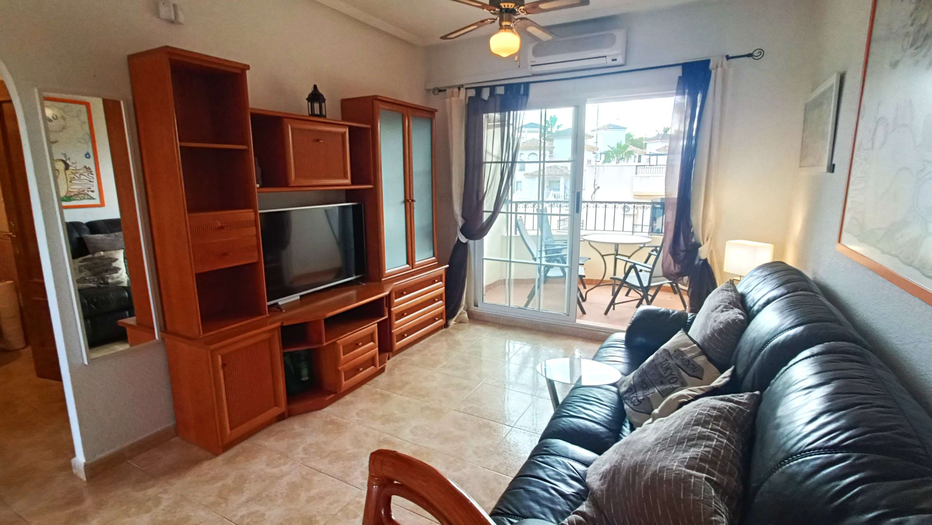 Accessed via a secure, gated entrance that offers both privacy and peace of mind, this well-presented apartment welcomes you into a bright and comfortable home. Upon entering, to the right you will find a fully fitted kitchen, complete with a window providing natural light and security grills.The property features an open-plan living and dining area with double sliding doors that lead out to a private balcony, creating a seamless indoor-outdoor living space. Along the hallway, there is a spacious family bathroom and two generously sized bedrooms, both benefiting from built-in wardrobes offering excellent storage.The balcony enjoys lovely open views of the surrounding area and is the perfect spot to relax and enjoy the Spanish sunshine.An additional highlight of the property is the communal rooftop area, where each second-floor apartment benefits from its own private solarium. This space offers fantastic 360-degree views and is ideal for sunbathing, entertaining, or enjoying summer meals with family and friends.The apartment is ideally located within walking distance of Villamartín Golf Course and the popular Villamartín Plaza, yet far enough away to enjoy a quiet and relaxed setting away from the hustle and bustle.Villamartín is a highly sought-after area on the Costa Blanca, renowned for its championship golf course, vibrant atmosphere, and excellent amenities. The famous Villamartín Plaza offers a wide selection of bars, restaurants, and shops, making it a popular social hub throughout the year. With beautiful beaches just a short drive away, excellent road links, and a strong international community, Villamartín is an ideal location for both permanent living and holiday homes.Call us today to arrange your viewing and take the first step towards finding your dream home. Our experienced agents specialise in this area and will be delighted to help you find the perfect property to match your lifestyle.