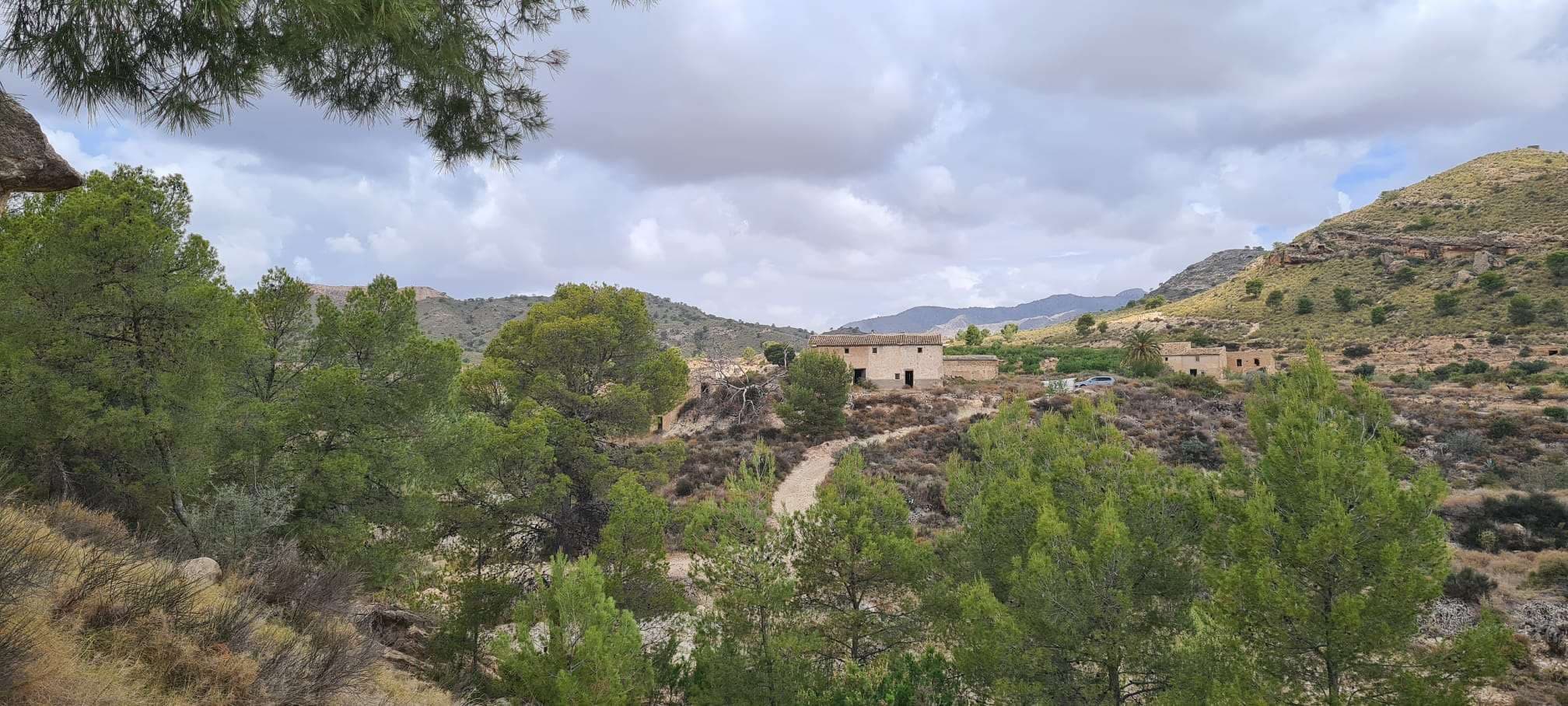 Discover a rare opportunity to acquire seven plots of land in the desirable area of Abanilla, totaling 366.454m² of rural land — perfect for a variety of future projects or development visions. Included on one of the plots is a 330 m² traditional farmhouse, that pre‑dates the 1900s, offering the potential for restoration, renovation, or conversion (subject to local planning consultation). There are also two service sheds on the land, providing additional functional space.The land features gently rolling hills and enjoys exceptional panoramic views of the surrounding countryside — an idyllic setting for rural living, retreats, or private estates.This holding is ideal for buyers looking for large plots of land with development potential in a peaceful yet accessible location. The expansive terrain provides a fantastic canvas for agricultural projects, or simply creating your own country estate.Situated in the heart of the Murcia countryside, Abanilla offers a tranquil rural lifestyle combined with convenient access to local amenities, traditional Spanish culture, and natural landscapes. The area provides easy connections to neighbouring towns, major road networks, and is a comfortable drive from coastal attractions and beaches of the Costa Cálida.