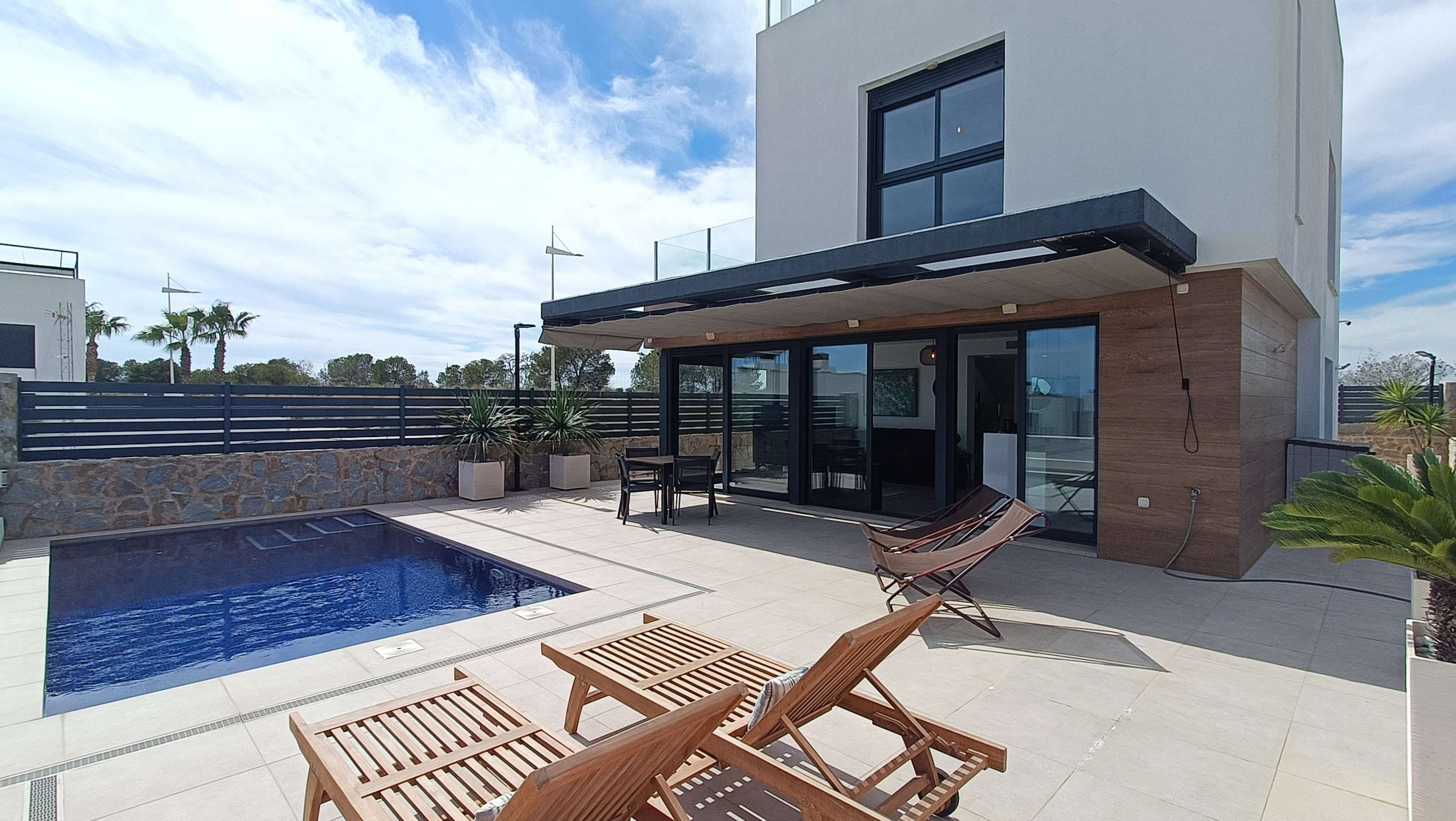 Stunning modern villa located in the prestigious and highly sought-after area of La Finca, offering a large underbuild with garage, private swimming pool, and a rooftop solarium boasting spectacular 360-degree views of the surrounding landscape.The ground floor features a bright and spacious open-plan living area, seamlessly connected to a fully fitted contemporary kitchen with a stylish breakfast bar. Expansive sliding doors flood the space with natural light and provide direct access to the pool area, creating a perfect indoor-outdoor living experience. This level also includes a generously sized bedroom with floor-to-ceiling built-in wardrobes and access to the terrace, along with a modern family bathroom complete with a walk-in shower.On the first floor, you will find two further spacious bedrooms, both with built-in wardrobes, including an impressive master suite with a private en-suite bathroom featuring a walk-in shower. The master bedroom also benefits from sleek sliding wardrobe doors with integrated automatic lighting, adding a touch of luxury and convenience. A second family bathroom serves this level.The villa boasts a substantial underbuild, thoughtfully designed with elevated walls to ensure privacy while offering uninterrupted views across La Finca. Currently used as a large garage, this versatile space offers endless possibilities, whether for additional living space, a gym, or entertainment area. A separate utility room provides practical storage and keeps household tasks discreetly tucked away. The garage door can be conveniently operated remotely via an app.Externally, the property offers extensive outdoor space, including a wraparound terrace that ensures sunshine throughout the day, as well as a private swimming pool with excellent privacy—ideal for relaxing or entertaining.This exceptional home is equipped with a wide range of premium features installed by the current owners, including:- Full-property WiFi (extending to the garage)- App-controlled air conditioning, exterior lighting, entrance gate and garage door - Underfloor heating throughout the main floor and all bathrooms,- A whole-house water filtration system- EV charging point - Digital video doorbell- A comprehensive Arlo security camera system.A truly turnkey property, perfectly designed for modern living, offering comfort, technology, and luxury in one of the area’s most desirable locations.La Finca Resort is a luxury golf and spa destination on Spain’s Costa Blanca in Algorfa, Alicante, combining superb golf with wellness and relaxation. The resort features a renowned 18‑hole championship golf course designed by Pepe Gancedo, known for its generous fairways, distinctive greens and stunning natural surroundings that offer an enjoyable challenge for golfers of varying skill levels.Alongside golf, the property includes a five‑star hotel with spa facilities, where guests can unwind with a range of treatments, hydrotherapy and wellness experiences in a peaceful Mediterranean setting. The resort also offers excellent amenities such as tennis and paddle courts, a fitness centre, several restaurants and bars, and easy access to nearby beaches, making it a great choice for both golf enthusiasts and those seeking a relaxing getaway.La Finca Golf & Spa Resort is located in the peaceful Algorfa area of the Costa Blanca, Alicante, set in a valley surrounded by citrus orchards, rolling hills, and open landscapes. The area combines a luxury golf resort with local amenities, including shops, restaurants, and the nearby traditional village of Algorfa, which offers a lively plaza, weekly market, and authentic Spanish atmosphere. Just 15–20 minutes by car from golden beaches like Guardamar del Segura and Torrevieja, as well as shopping destinations such as La Zenia Boulevard, La Finca benefits from a Mediterranean climate with over 300 days of sunshine, making it ideal for golf, outdoor activities, and a relaxed lifestyle.