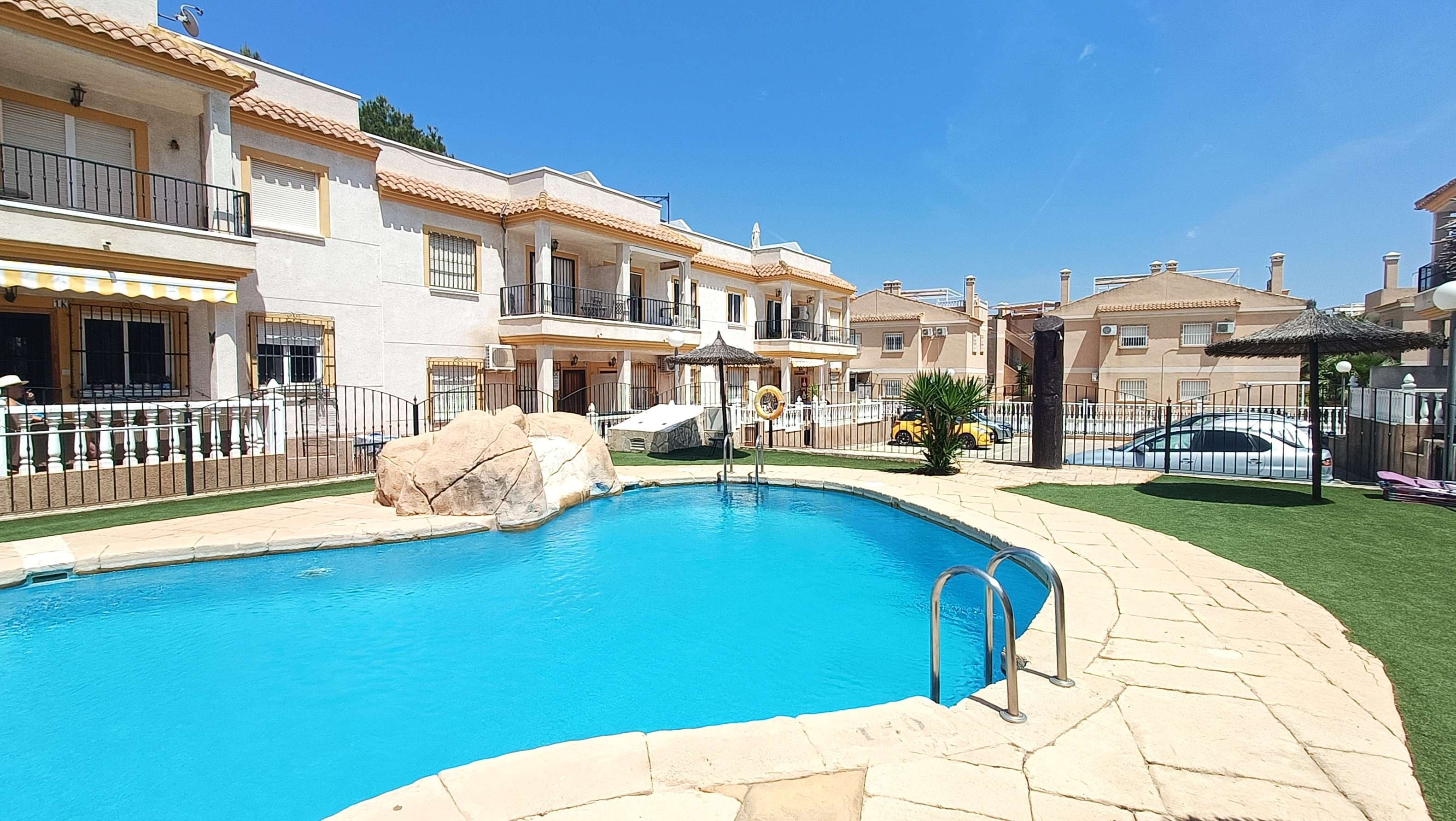 This beautiful two-bedroom top floor apartment is located within a secure gated community in Montemar.Upon entering the property, you are welcomed into a bright and modern open-plan living area with a fully fitted kitchen. On the same level, the apartment offers two bedrooms—one with built-in wardrobes—and a well-proportioned family bathroom.Just off the lounge, there is a charming balcony overlooking the communal pool, providing the perfect spot to enjoy a morning coffee in the sunshine.The standout feature of this apartment is the spacious private solarium, offering stunning 360-degree views of the surrounding area. This versatile space is ideal for entertaining family and friends, sunbathing during the summer months, or enjoying relaxed evening barbecues.The property benefits from being located within a gated community, offering excellent security, along with access to communal parking and a well-maintained swimming pool.Montemar is a peaceful and well-established residential area, popular with both permanent residents and holiday homeowners. Situated close to the renowned La Finca Golf Resort, it offers a relaxed setting while still being within easy reach of local amenities, restaurants, and shops. The area is just a short drive from the beaches of the Costa Blanca and benefits from excellent access to nearby towns and transport links, making it an ideal location for both lifestyle and investment.